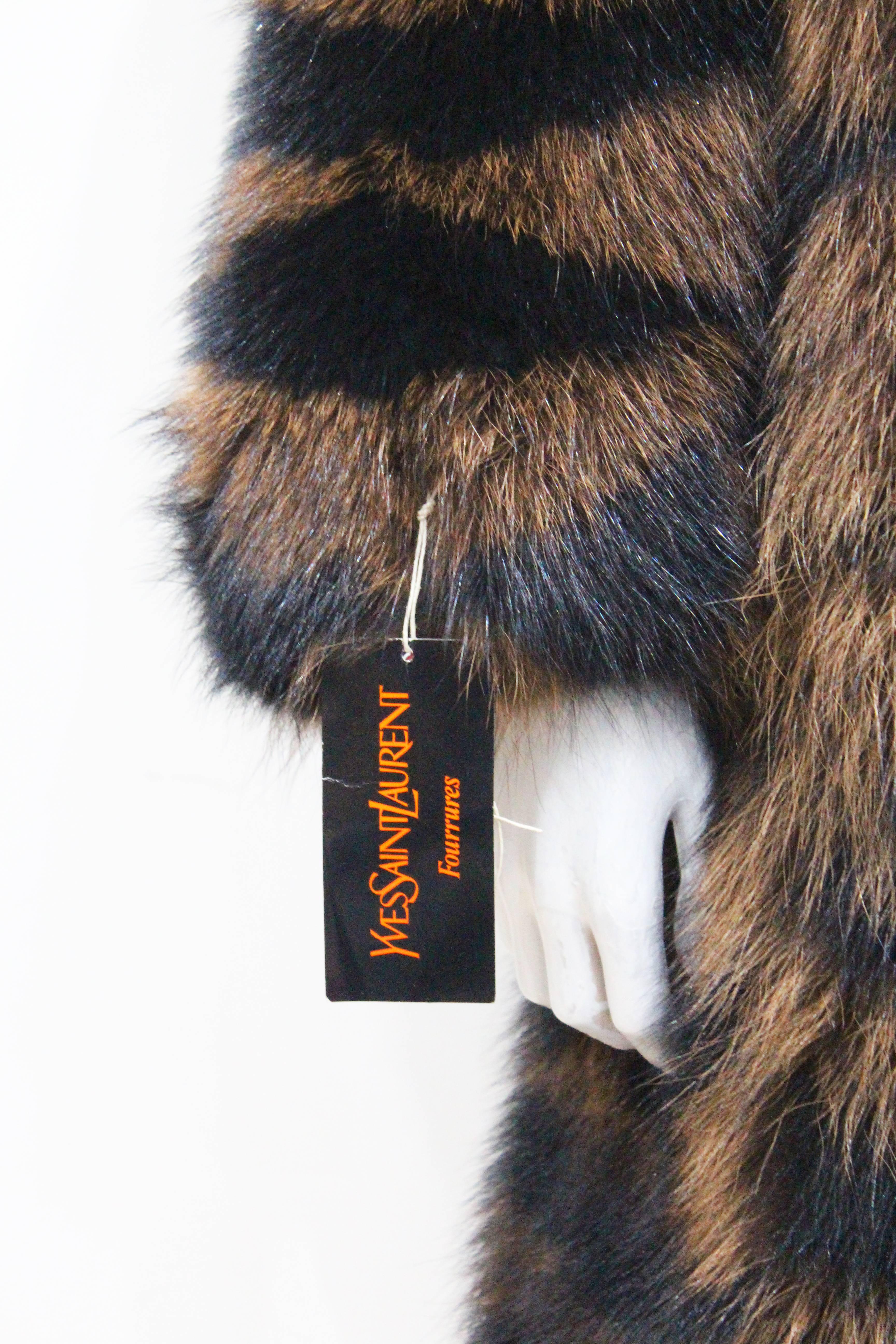 A Yves Saint Laurent beaver fur coat from the 1980s. The coat is in an oversized style and lined with 'YSL' monogram silk. No closure and hangs loosely. 

Brand new/unworn 

Fr 40 / UK 12 / Medium 