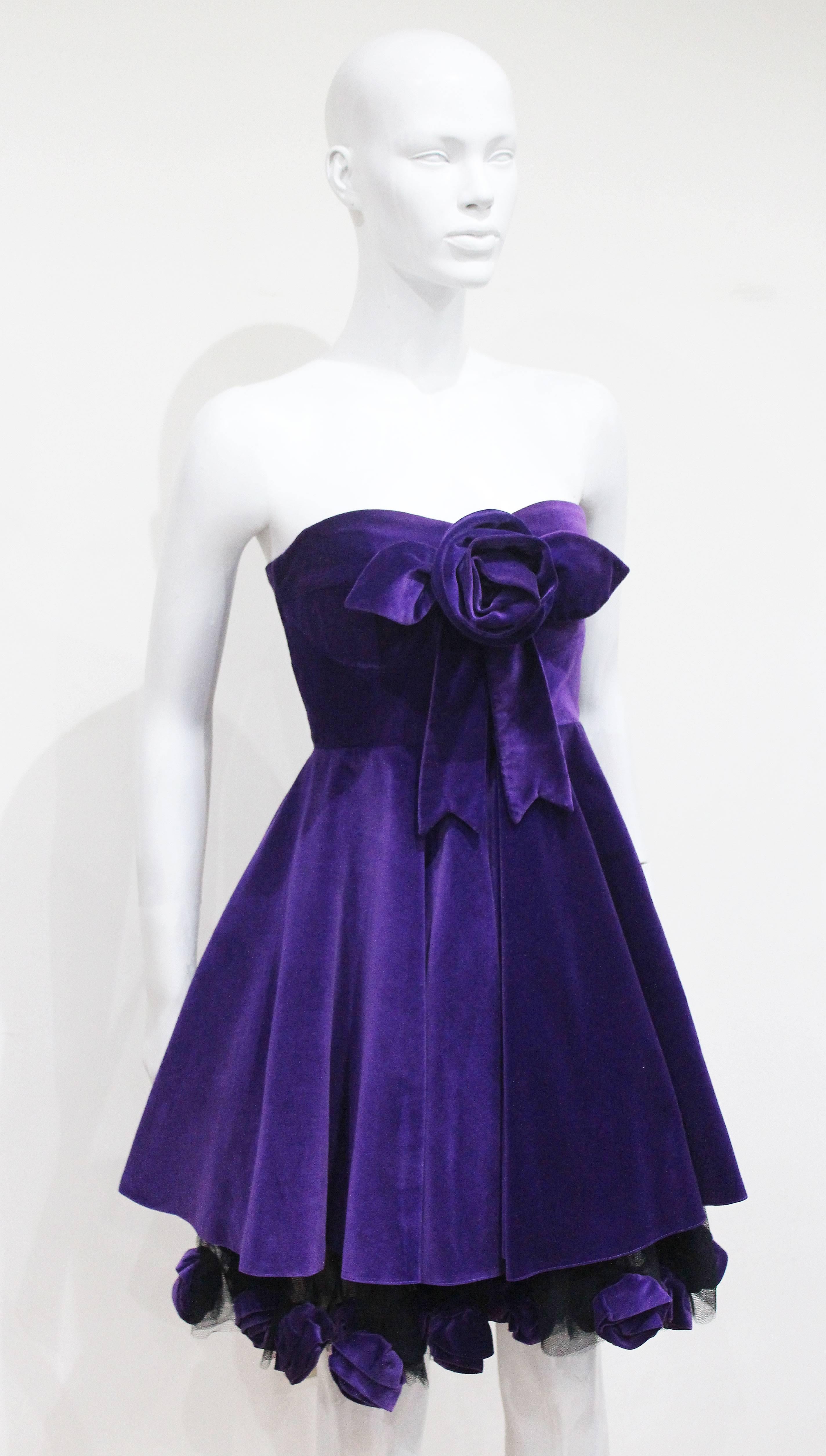 A Monica Chong floral applique cocktail dress in purple velvet from the year 1992. 

