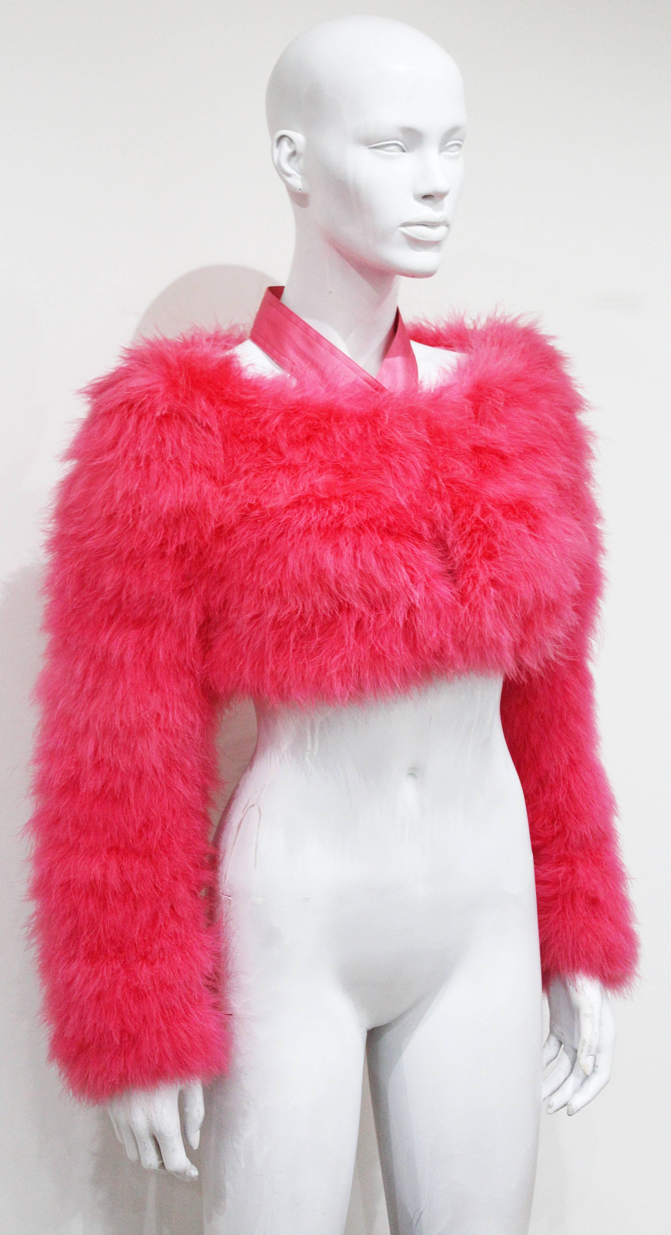 A marabou fur bolero in hot pink from the Spring/Summer 2004 runway collection. The bolero was designed by Tom Ford for Gucci. 100% silk halter neck design and lining. 

Size: French 38 / Italian 42