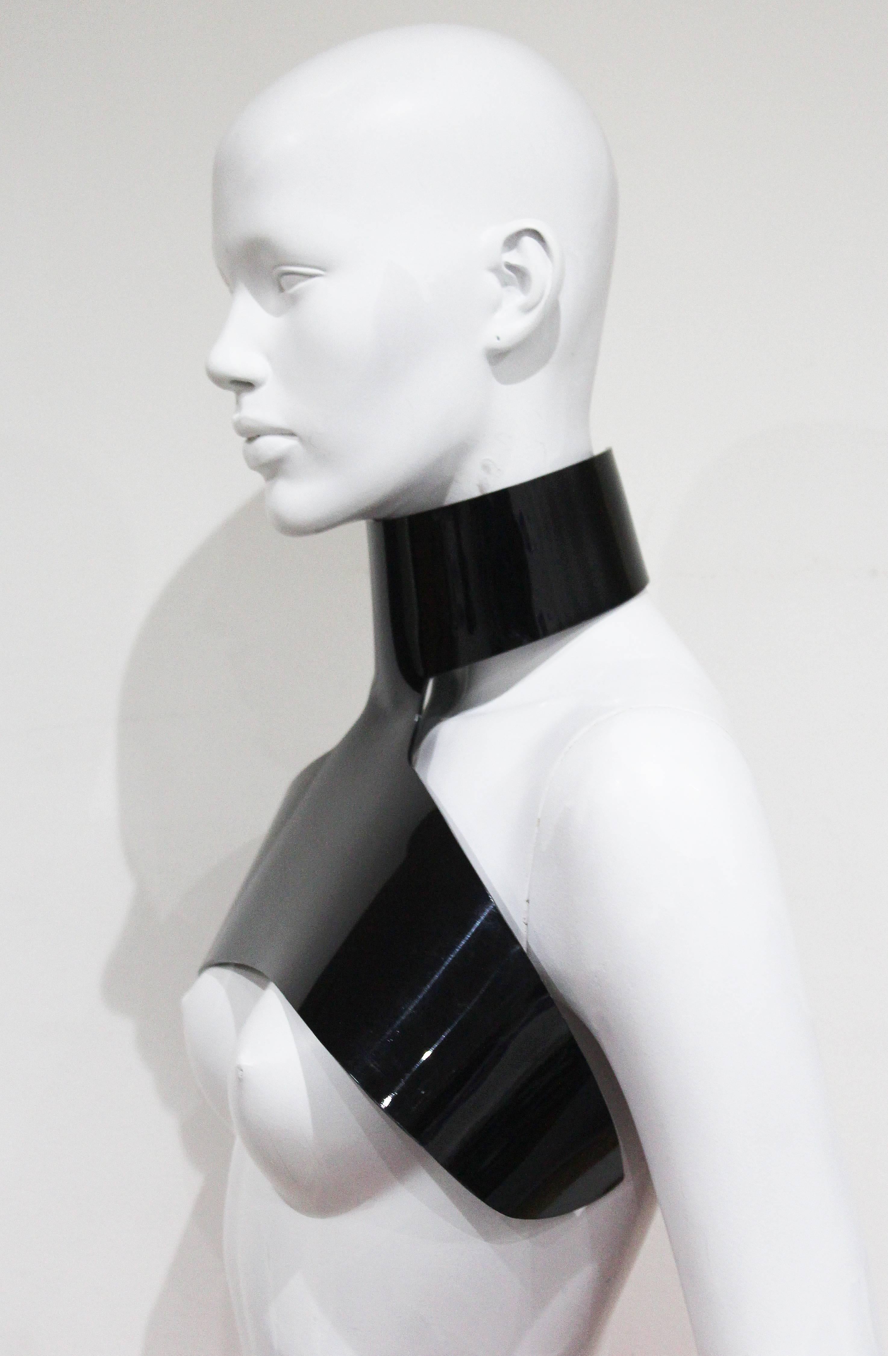 An Yves Saint Laurent by Stefano Pilati harness choker from the Autumn/Winter 2006 collection. The choker wraps around the neck and under the arms just above the bust. 

XS - Small 