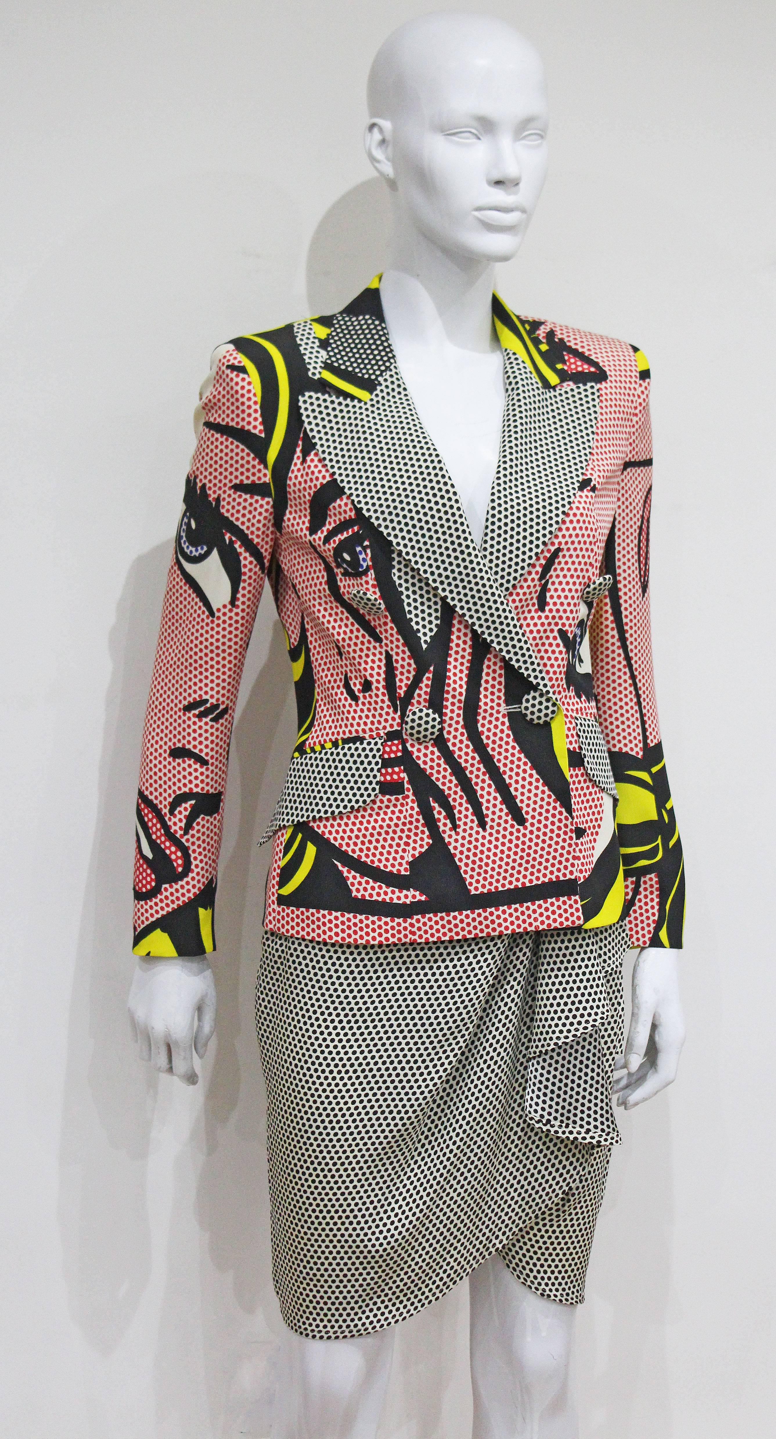 A museum worthy Moschino skirt suit from the Spring/Summer 1991 collection. The suit features the iconic Roy Lichtenstein 'M-Maybe' print throughout. The blazer is tailored, double-breasted and features a silk scarf style lining which is dated. The