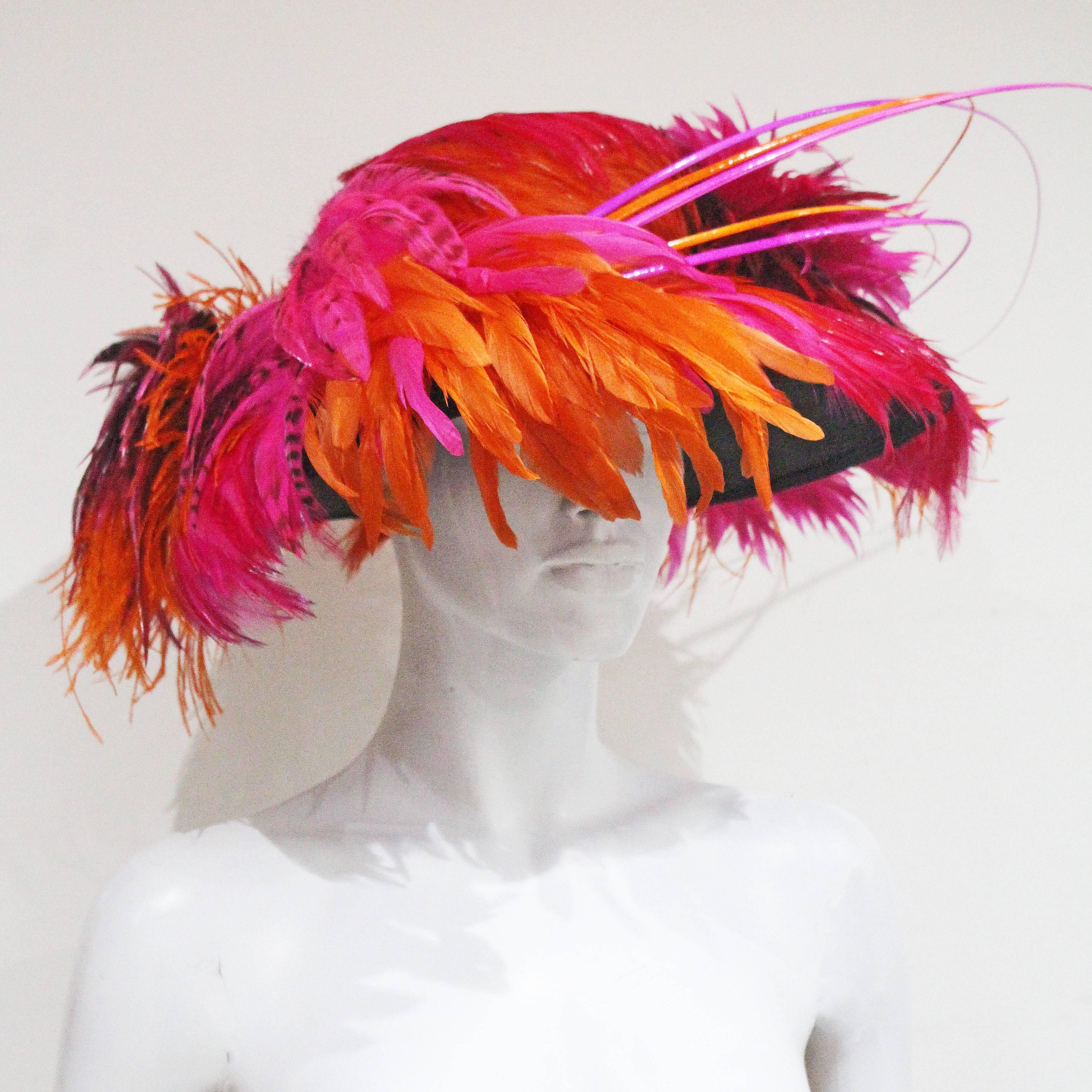 An incredible wide brim hat from the Stephen Jones millenary. The hat was named 'Jungle Green' and was inspired by tropical flowers. This piece was hand made and each individual feather was placed strategically to resemble flowers and plants. This