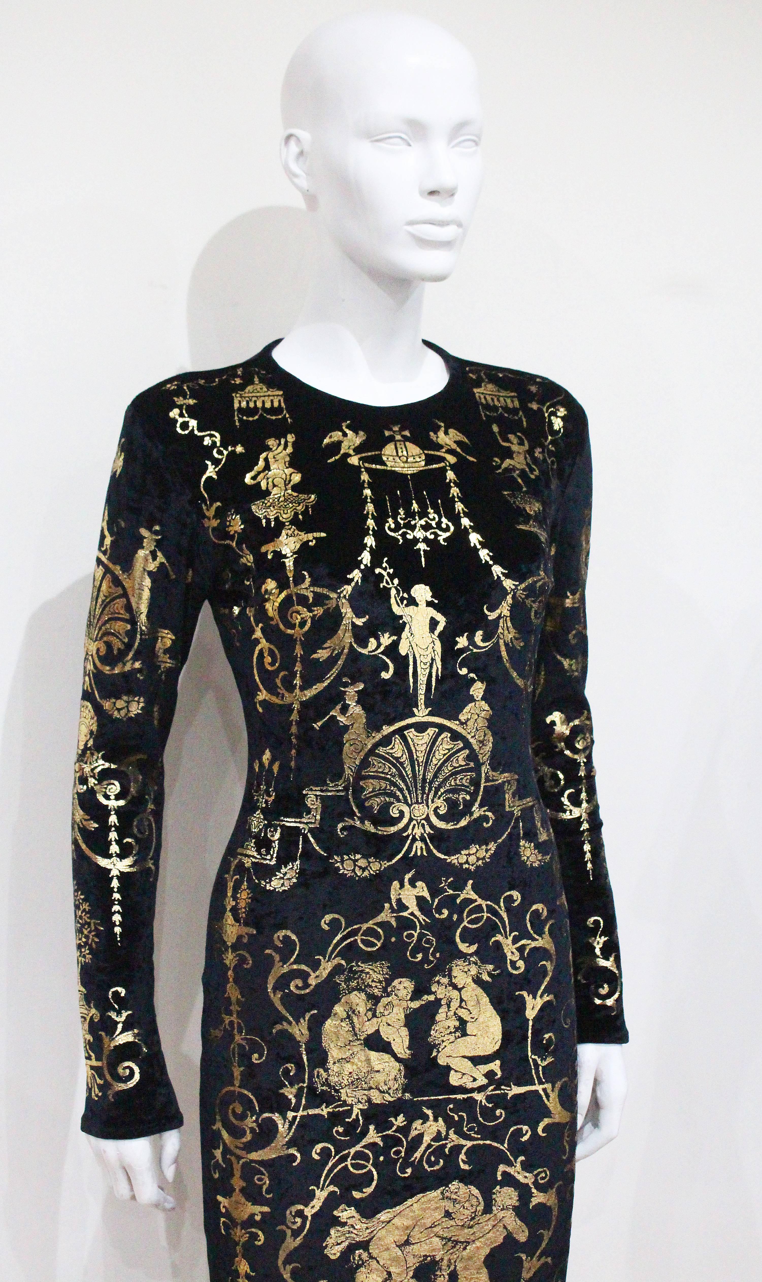 This dress comes from the famous A/W 1990 'Portrait' Collection. This full length body con dress is made of black velvet with gold leaf, this was inspired by the Rococo furniture decorated with the Boulle technique (the technique of inlaying brass