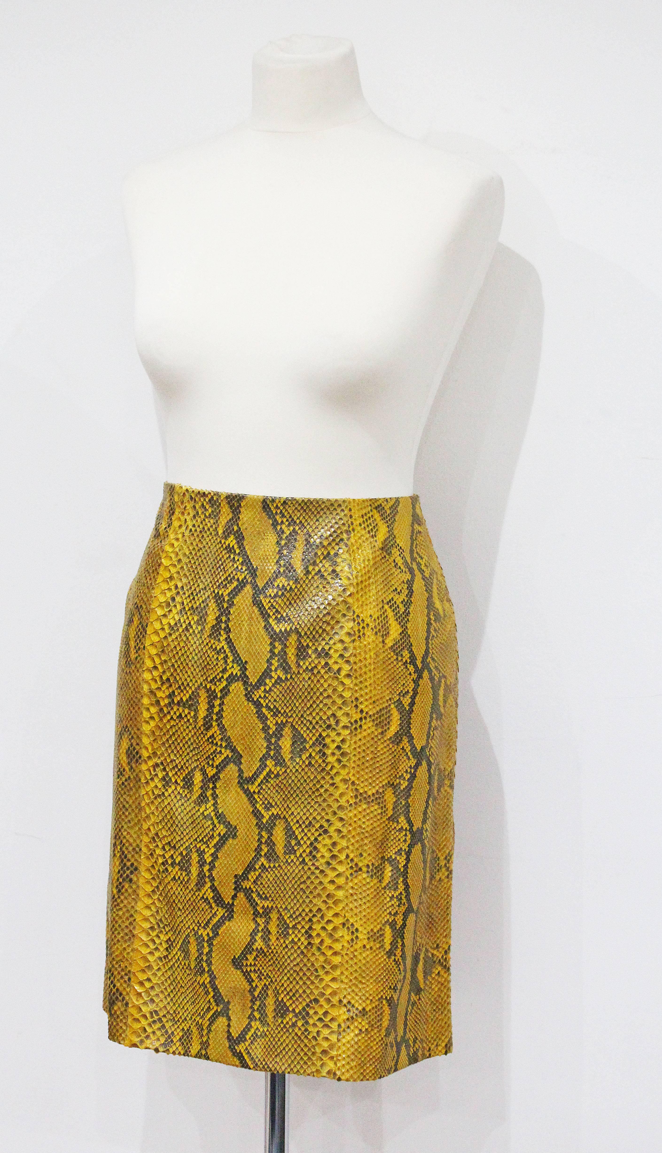 A Gianifranco Ferre pencil skirt from the 1990s in yellow python skin. 

It 44 - French 40 