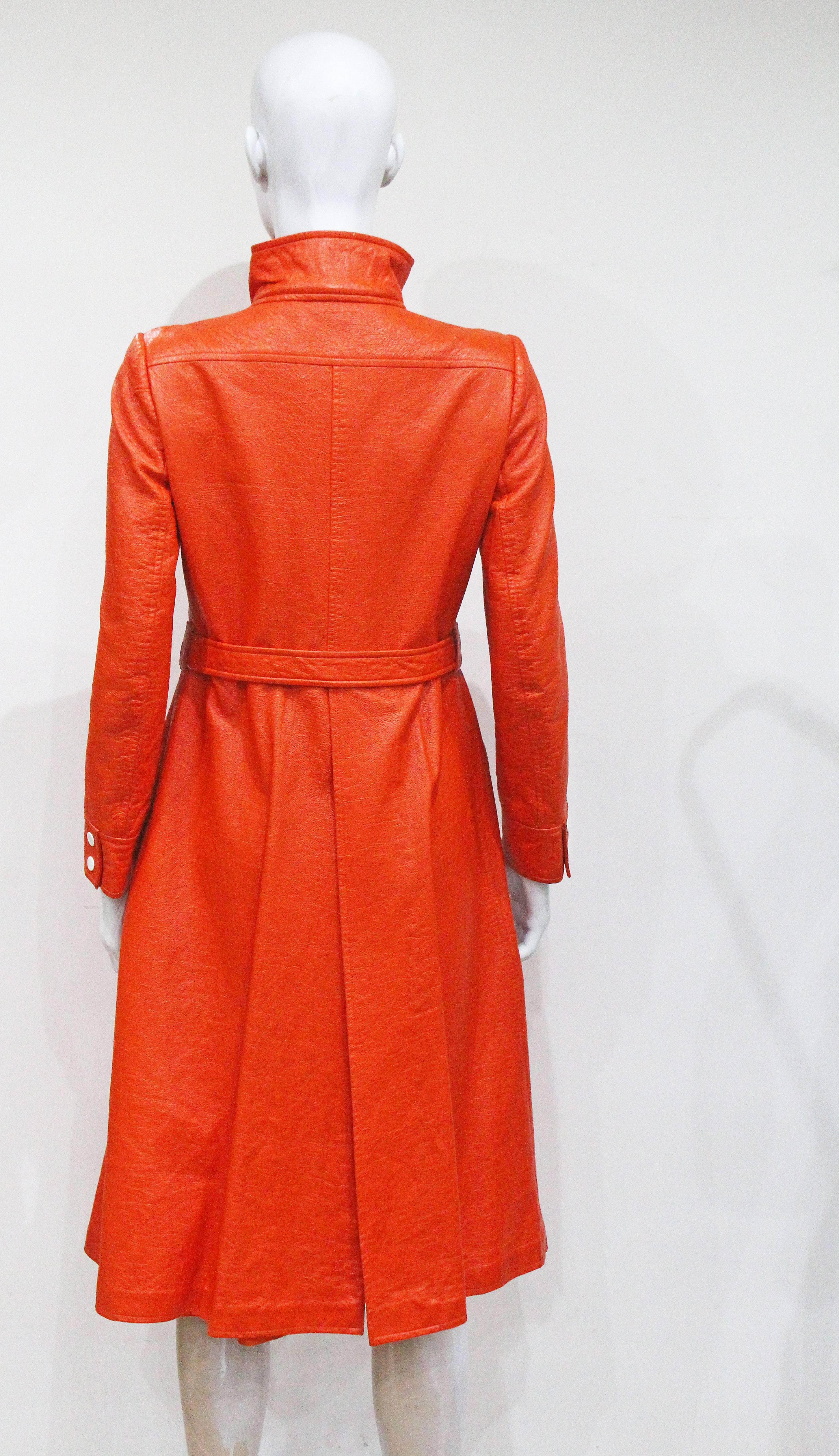 Women's Courreges orange vinyl coat dress, c. 1970