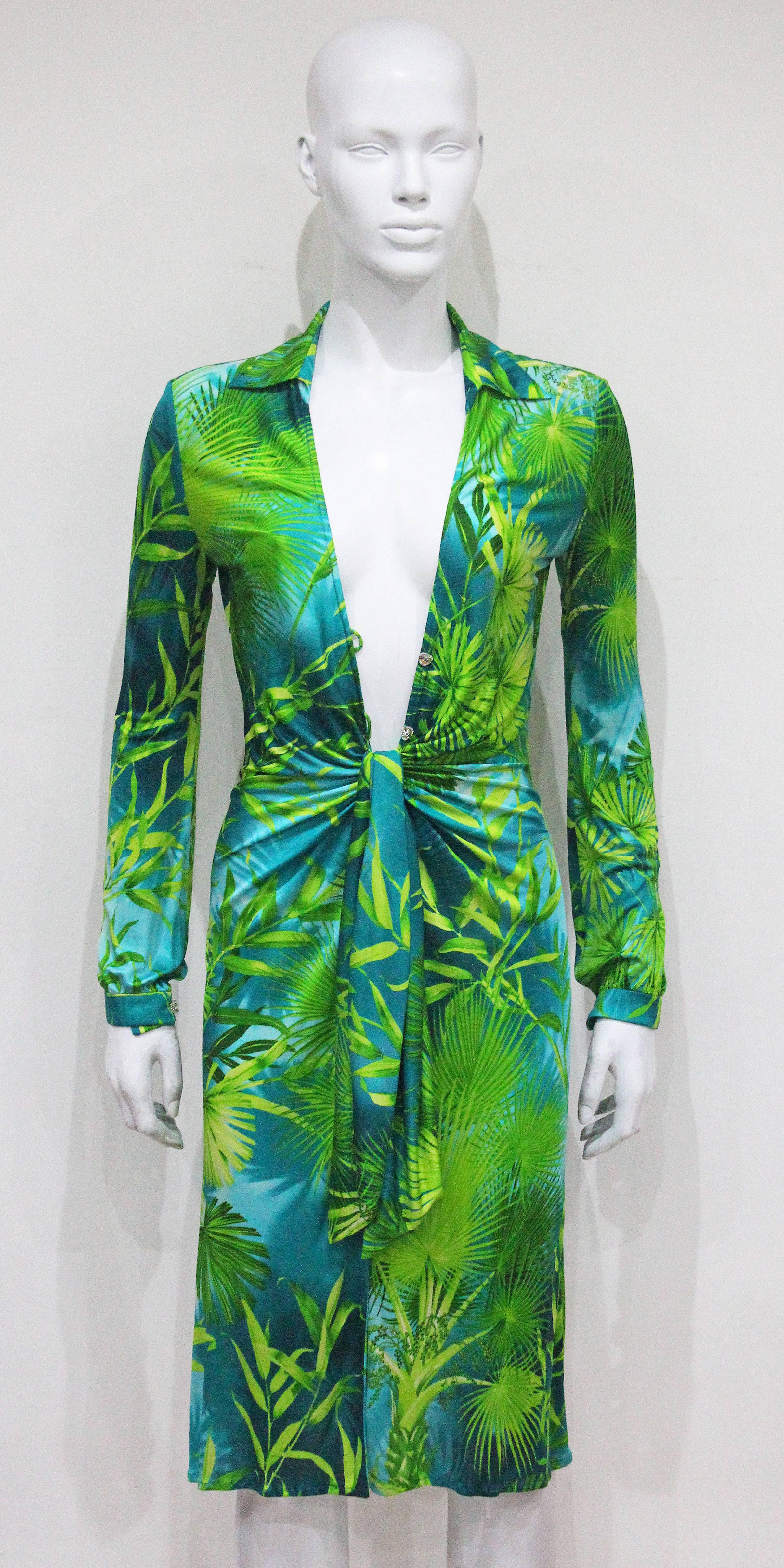 An important piece of Versace history the Gianni Versace jungle print super low plunge silk jersey dress from the Spring/Summer 2000 runway collection as worn by Versace muse Amber Valletta. The dress is 100% silk jersey and features the infamous