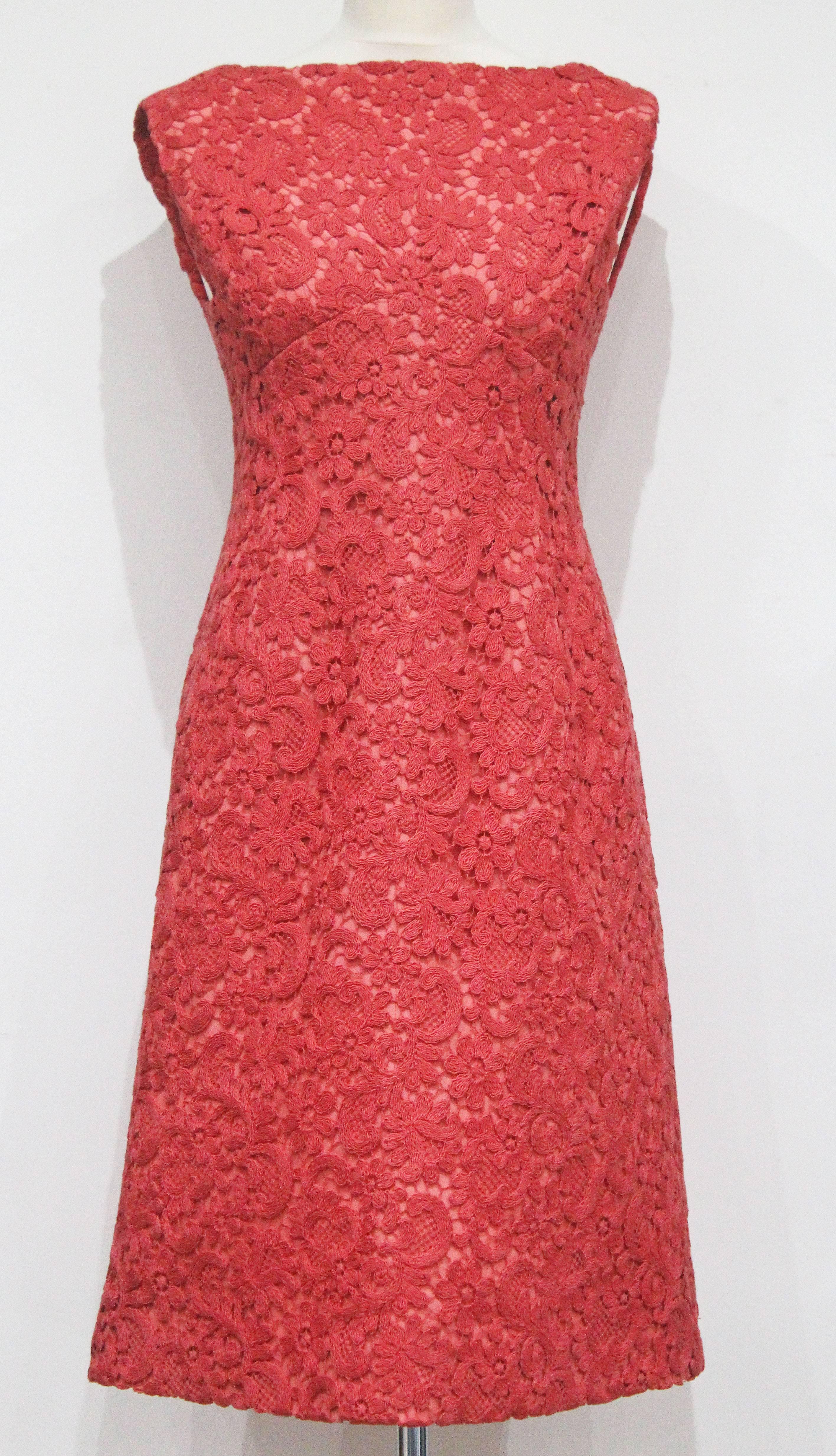 A haute couture macrame lace Rose Bertin structured  A-line dress in coral silk. Audrey Hepburn famously wore Rose Bertin designs during the 1960s and early 1970s, all the designs were made to order for very special clients. 

No size label,