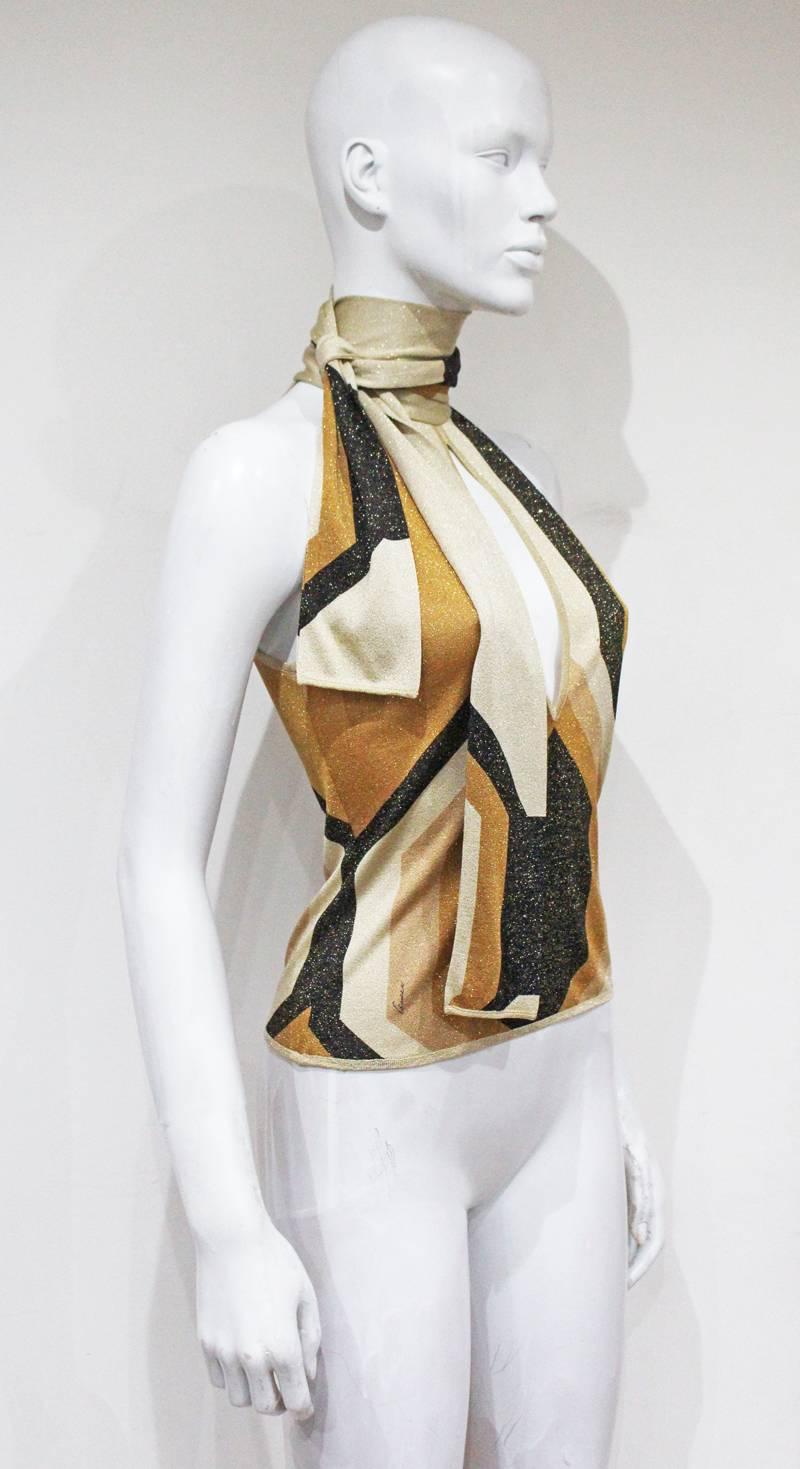 A Tom Ford for Gucci lurex evening gown from the Autumn/Winter 2000 runway collection. The blouse features a gold lurex geometric print with an attached neck tie.

XS