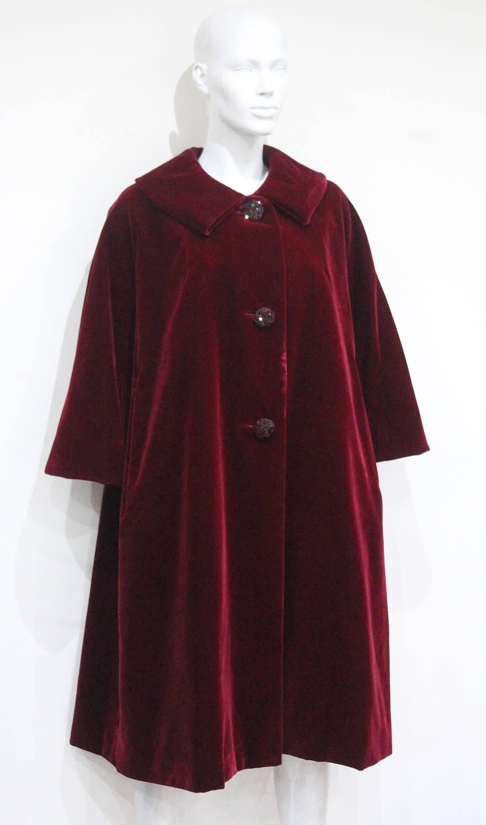 One of a Kind is proud to offer a Haute Couture Autumn/Winter 1956 extremely rare silk velvet opera coat by the house of Christian Dior. 

This evening opera coat oozes elegance with great simplicity and cut of a swing style. The coat is made of