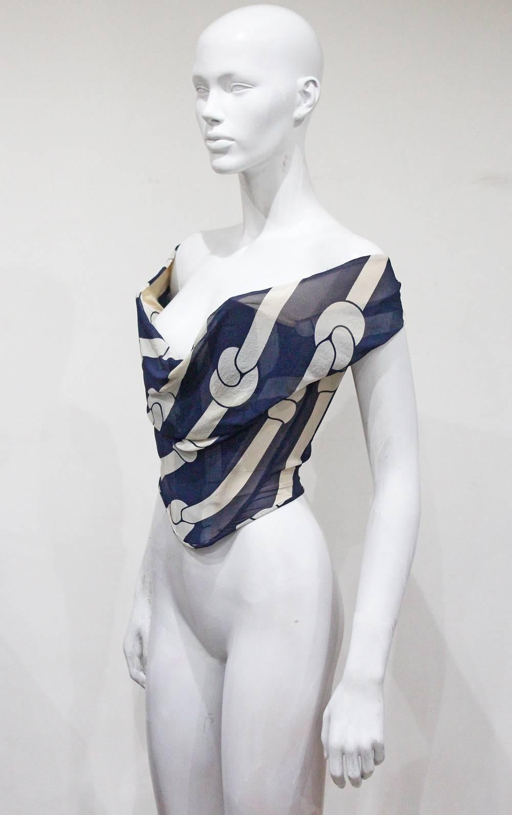 A Vivienne Westwood runway silk chiffon corset from the Spring/Summer 1998 collection. The corset is boned inside and features a nautical rope inspired navy print and off the shoulder cut.

Small
