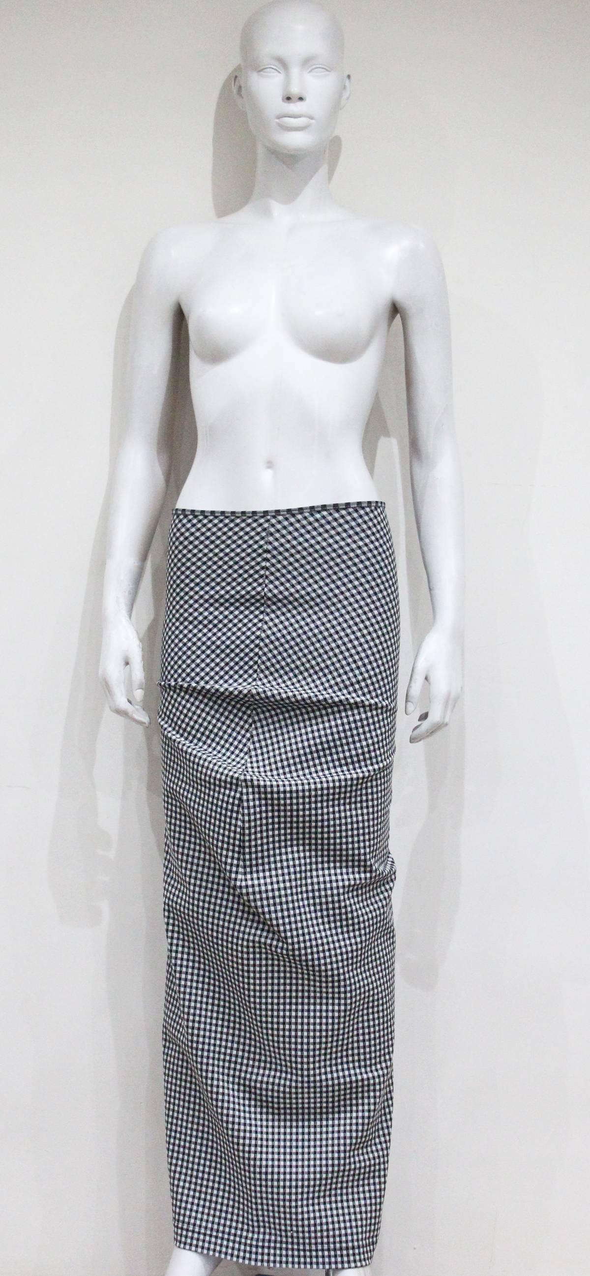 An exceptional and rare COMME des GARCONS / Rei Kawakubo skirt from the 'Body meets dress, dress meets body' / 'Lumps and bumps' spring/summer 1997 collection. The skirt of stretch nylon features a black and white checked gingham print and has