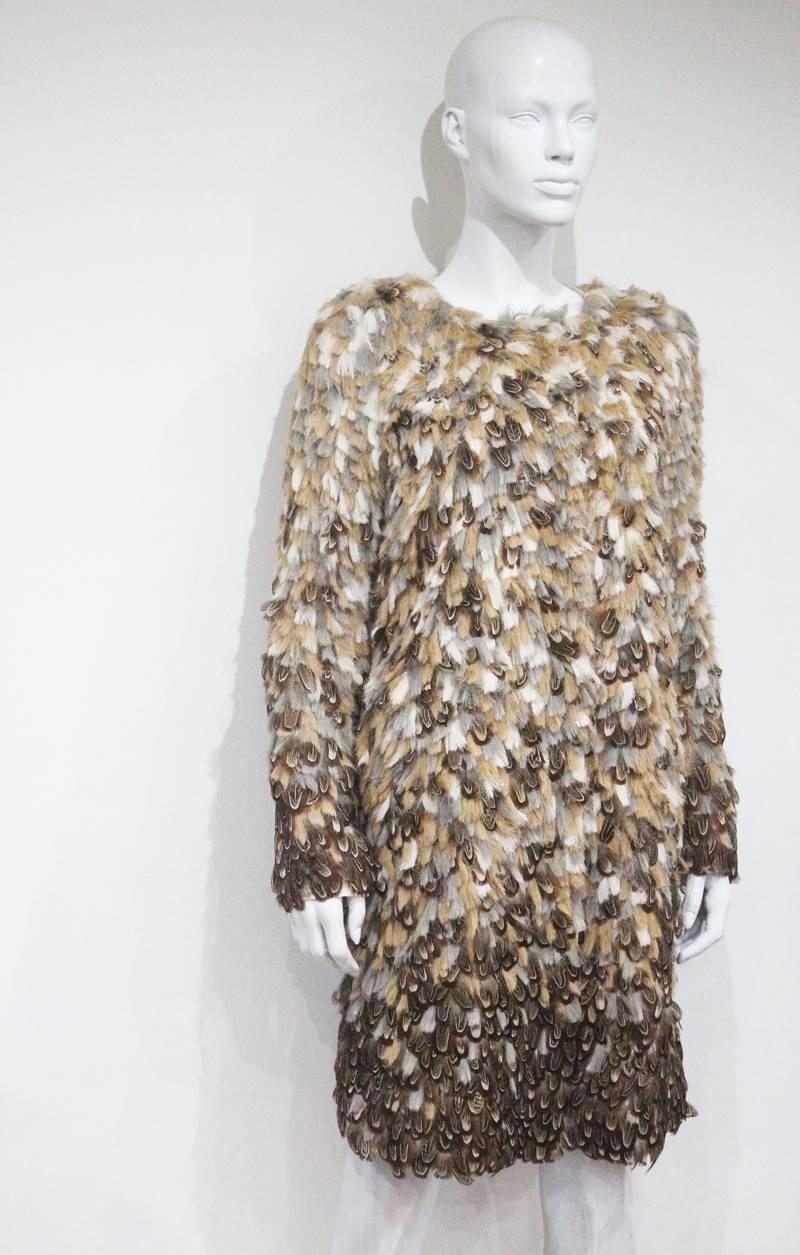 An 1990s evening coat by Escada made of pheasant feathers and silk. 

Fr 36 