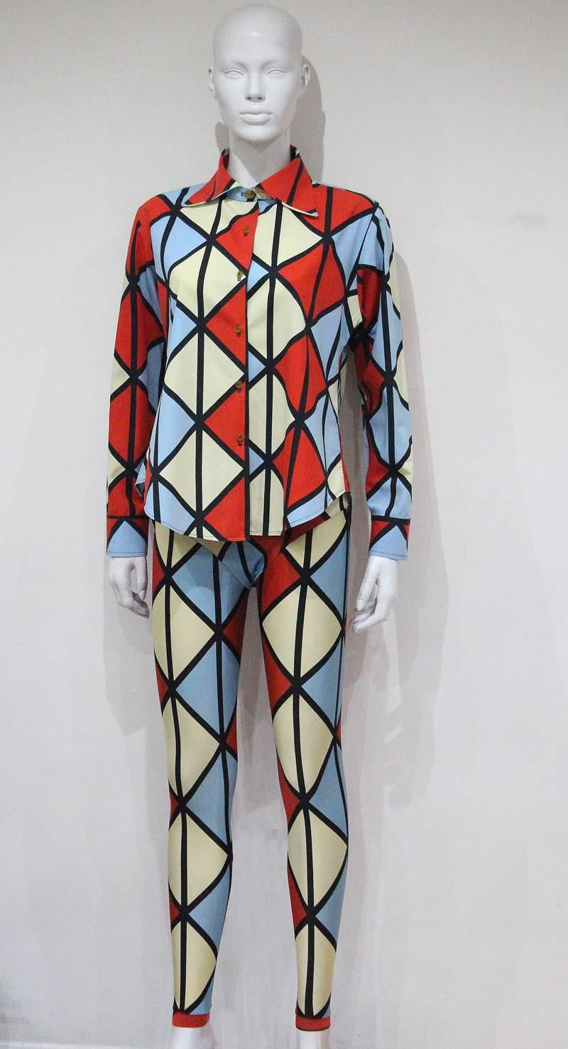 Voyage to Cythera, AW 1989-90

Vivienne Westwood harlequin ensemble from one of Vivienne Westwood's most recognisable and iconic collections. The ensemble includes a cotton button up shirt and high waisted leggings. 

Shirt - M
Leggings - S/M