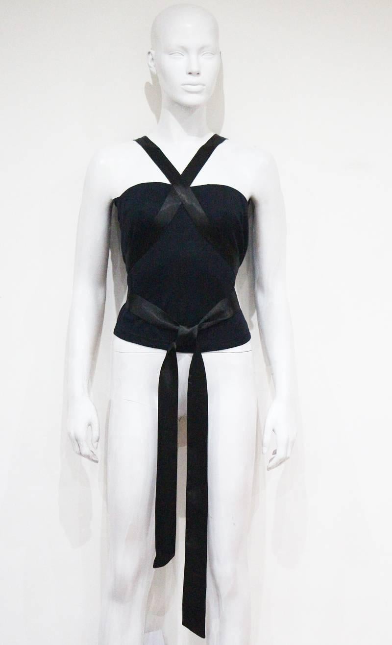 An early Alexander McQueen bondage evening vest of black jersey with extra long satin ties which wrap around the body. 

Small