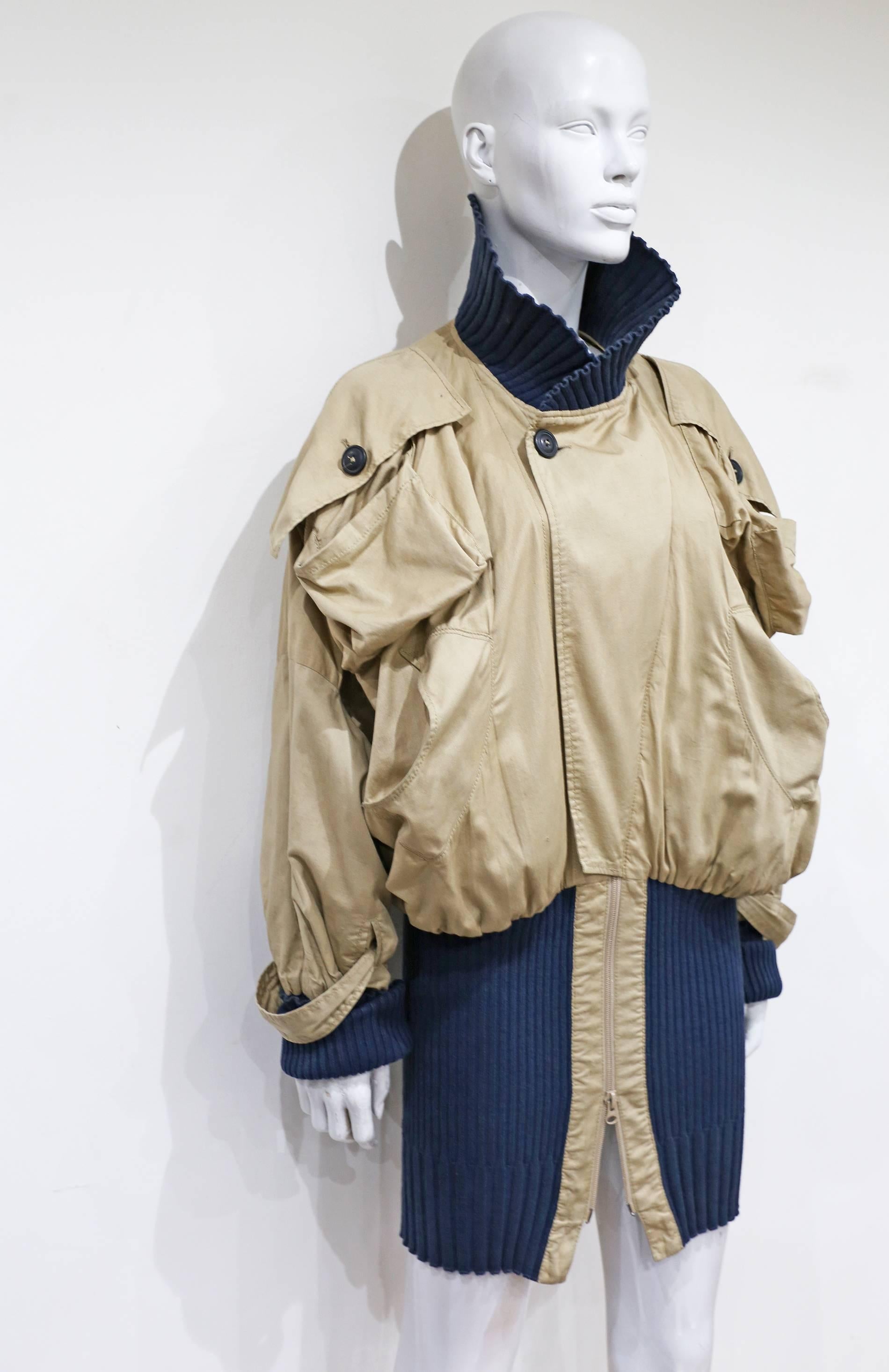 An oversized Vivienne Westwood 'Clint Eastwood' bomber jacket in beige cotton with extra long navy rib-knit cuffs, collar and waist band. 

S/M