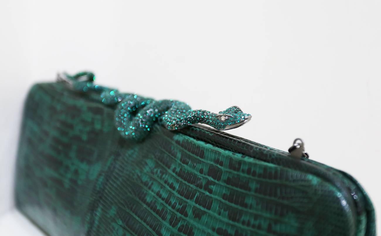 Fine and rare Valentino dark green genuine lizard skin evening bag/clutch with encrusted crystal snake closure, silk satin black interior and optional metal shoulder chain which can be put inside of the bag to be worn as a clutch. 