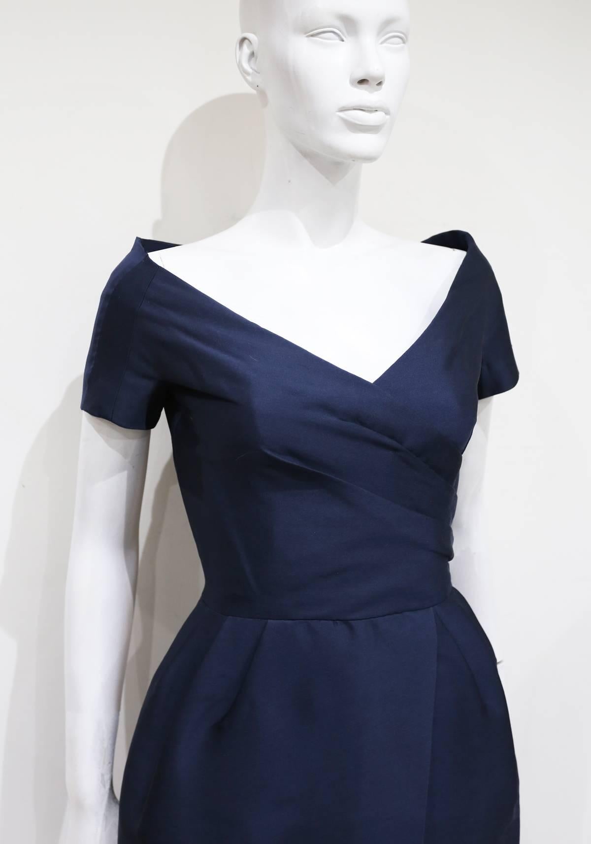 An absolutely beautiful couture Rose Bertin silk cocktail dress, circa 1950s. The dress has an off-the-shoulder design with pleating across the bust and waist. Inside is a boned corset giving the dress a structured silhouette. Rose Bertin was a