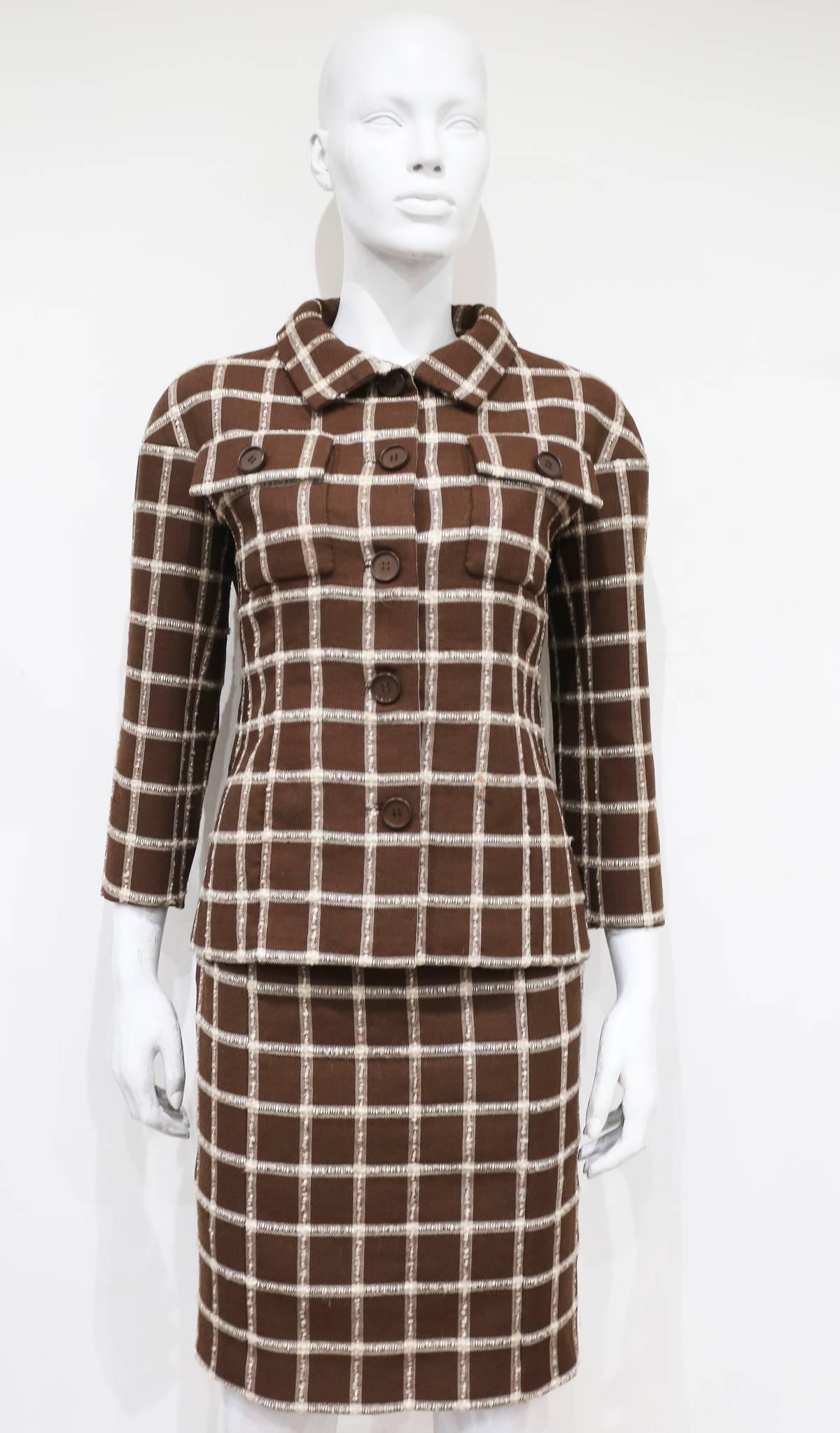 A couture Balenciaga checked woollen skirt suit, circa 1965. The jacket is exquisitely tailored and has a slightly boxed shoulder giving it the classic Balenciaga silhouette. The suit is lined in black silk. Made for the EISA label. 

 