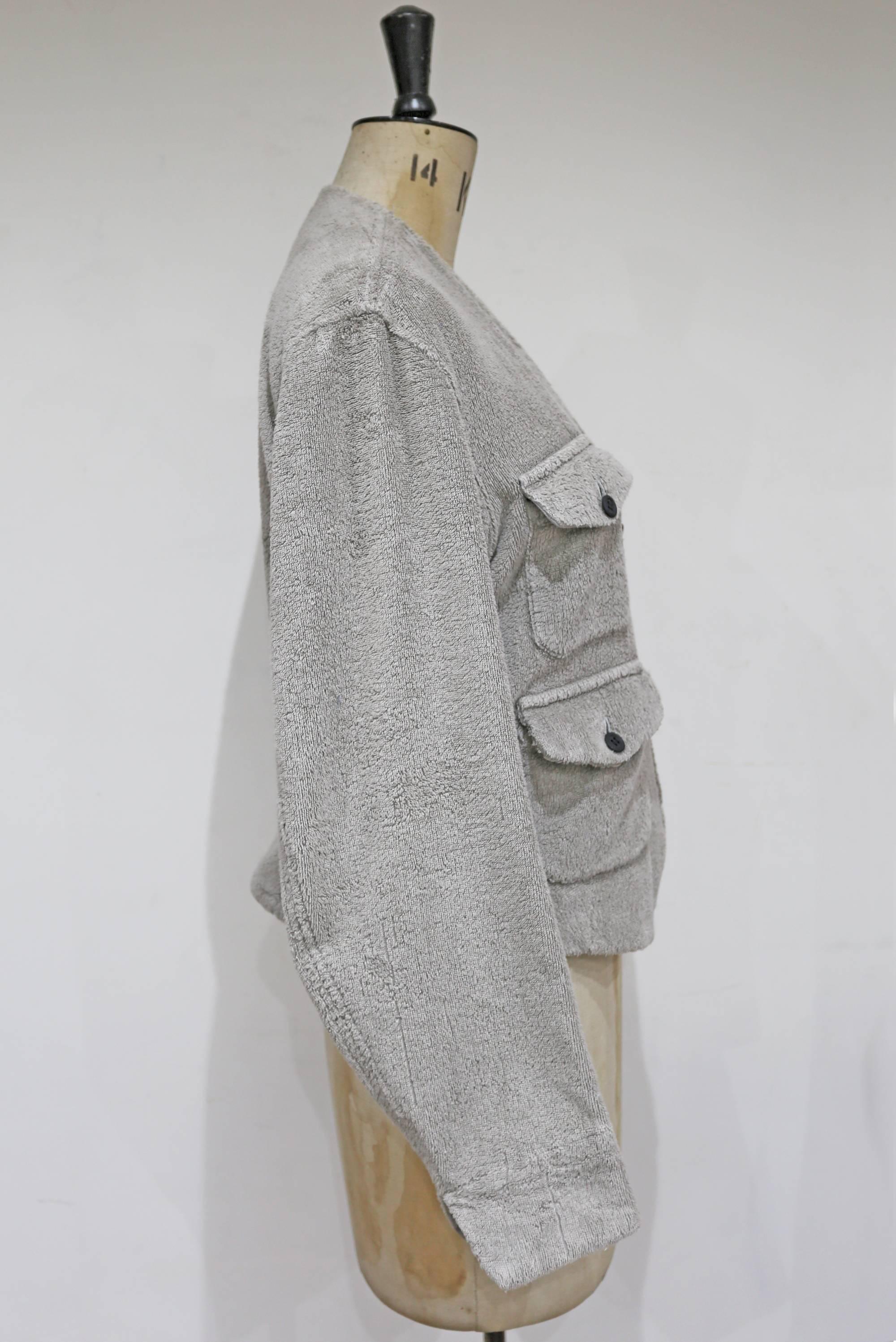 Ultra rare and highly collectible Seditionaries towel jacket, circa 1976. The jacket is made of grey towelling fabric and features rubber buttons and four front flap pockets.

M