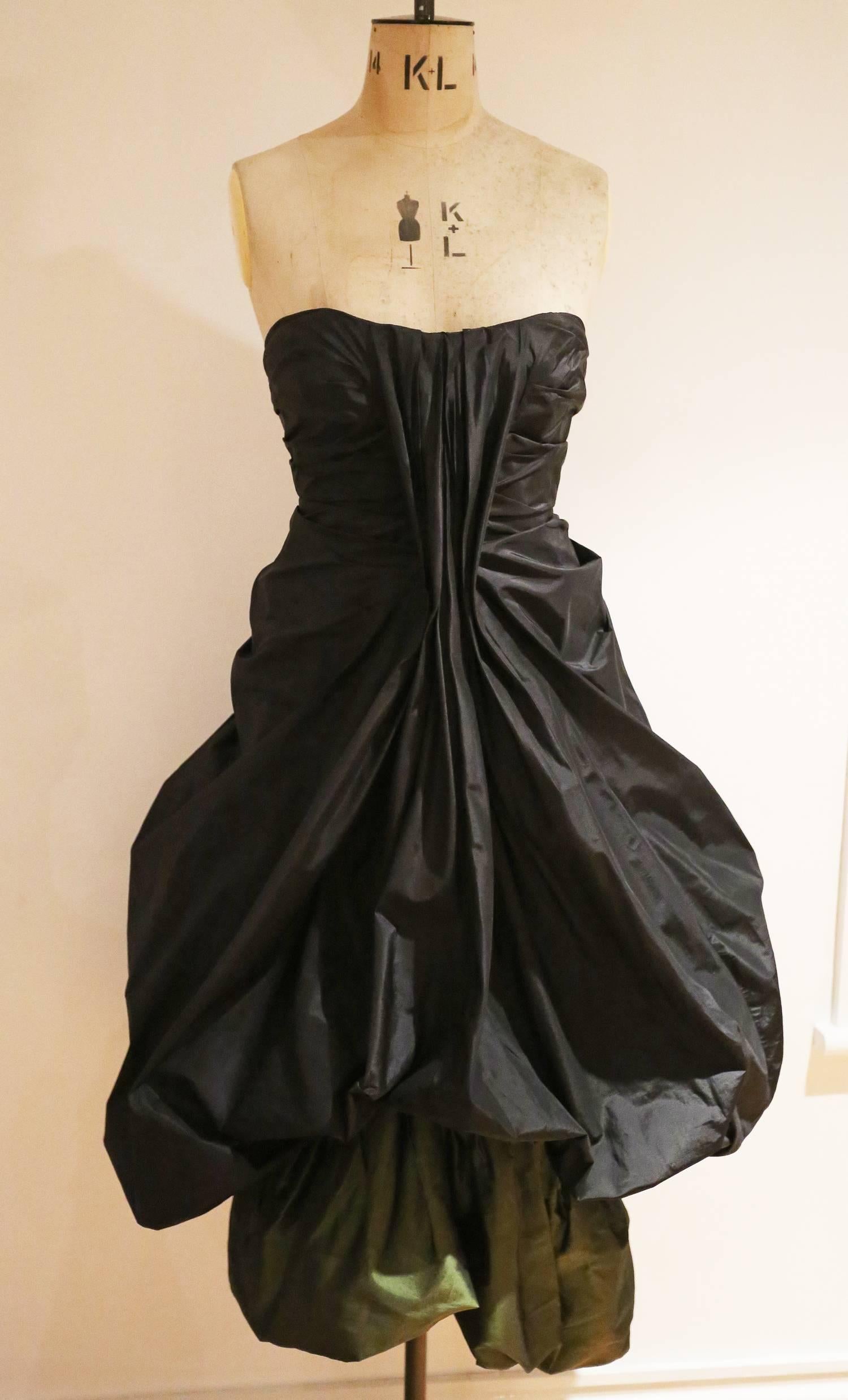 Extremely important and rare Alexander McQueen strapless silk taffeta evening dress from the witches collection, Autumn-Winter 2007. The dress features beautiful pleating throughout with an amazing ballon skirt and petrol green underskirt. There is