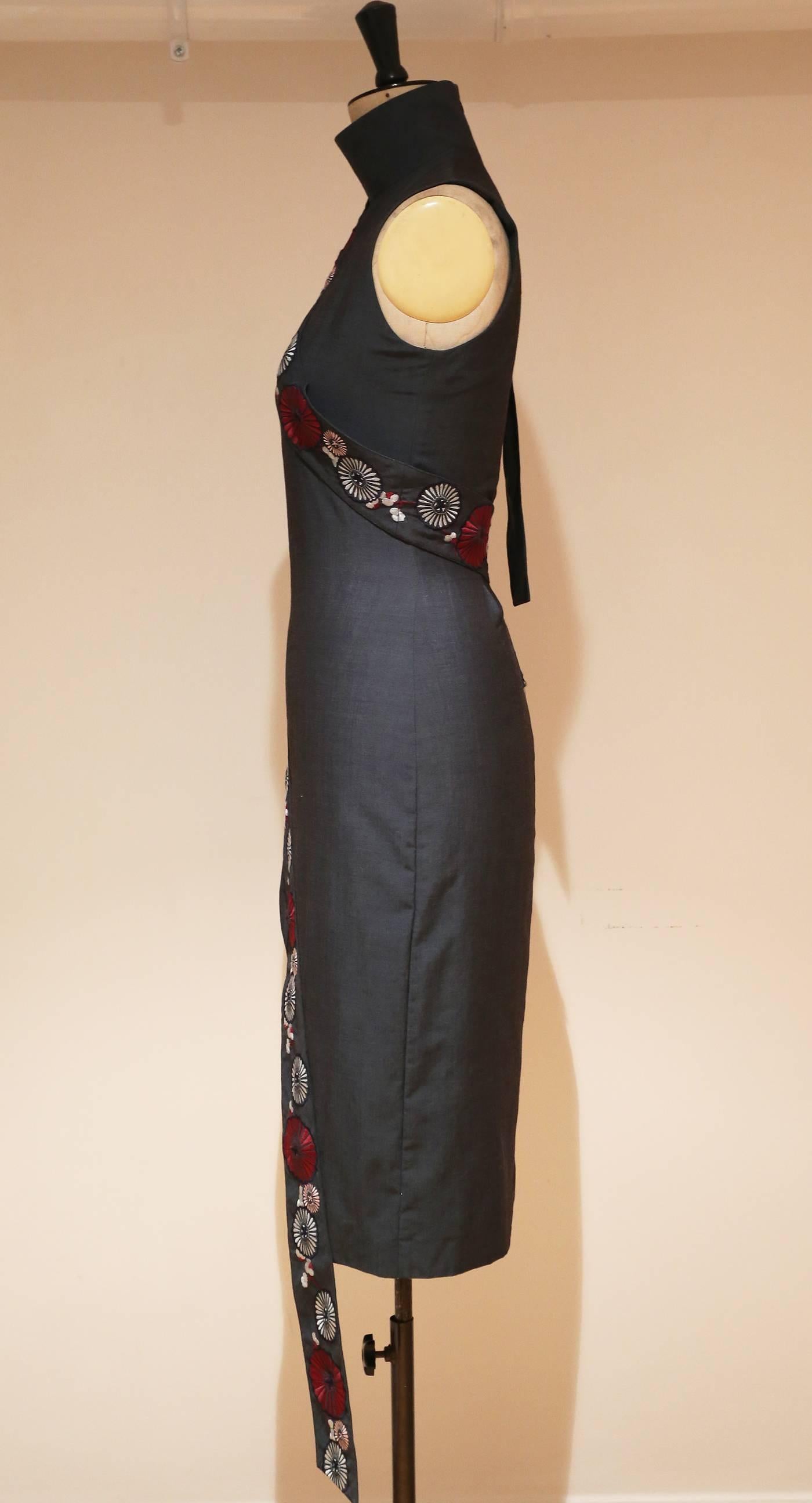 Highly sought after and rare Alexander McQueen VOSS dress from arguably his most iconic collection, Spring/Summer 2001. The dress is in a grey wool and inspired by an cheongsam style dress. 

European 40  Italian 38  UK 12 