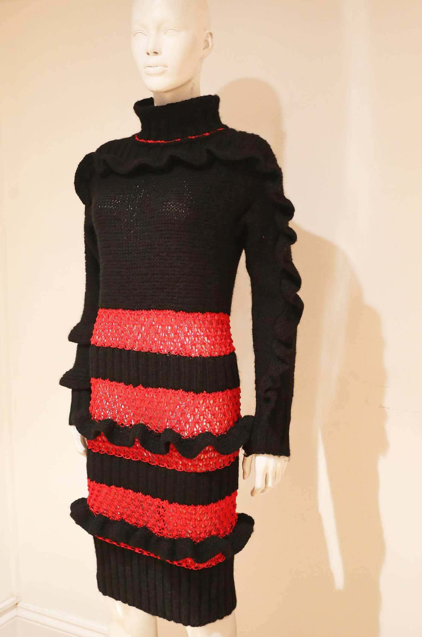  A knitted dress designed by Bodymap. The designers Stevie Stuart and David Holah formed the company, which had a reputation during the 1980s for producing innovative layered clothing.

This dress is hand-knitted from black cotton, with ribbing at