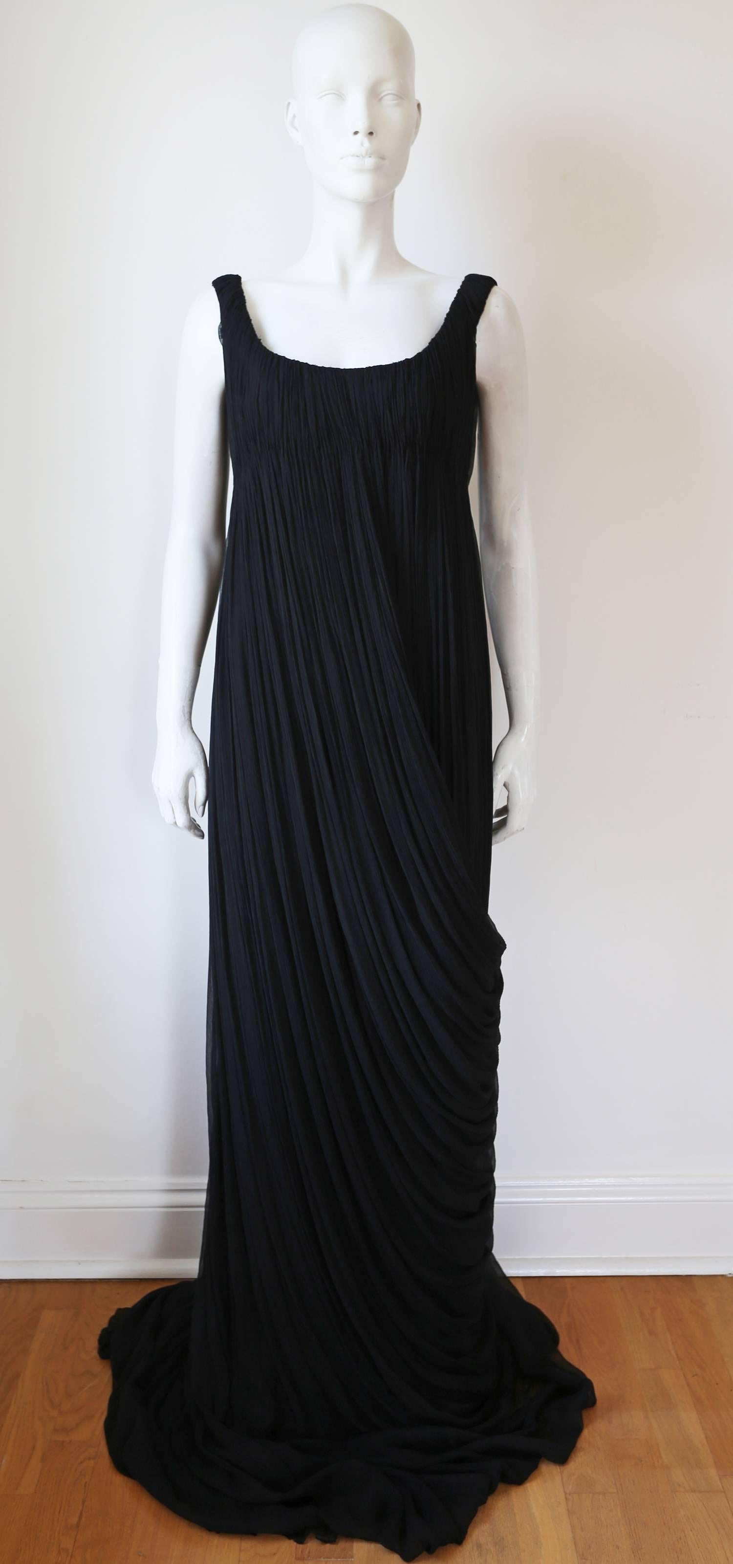 A spectacular and rare evening dress by the late and great Alexander McQueen from the 'The girl who lived in the tree' A/W 2008 collection. 

The dress is in black silk chiffon which has been heavily pleated giving it a Fortuny Delphos inspired