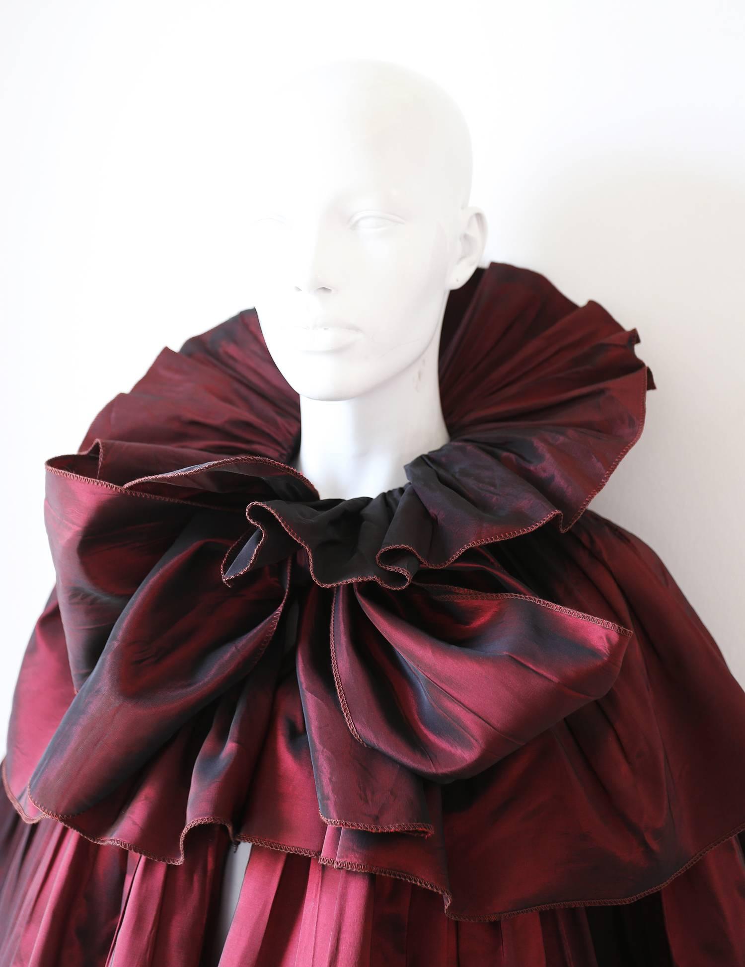 Extraordinary Roland Klein at Marcel Fenez two tone silk taffeta evening cape from the 1980s. The cape features ruffled tiered design with a long sash fastening around the collar. 

One Size