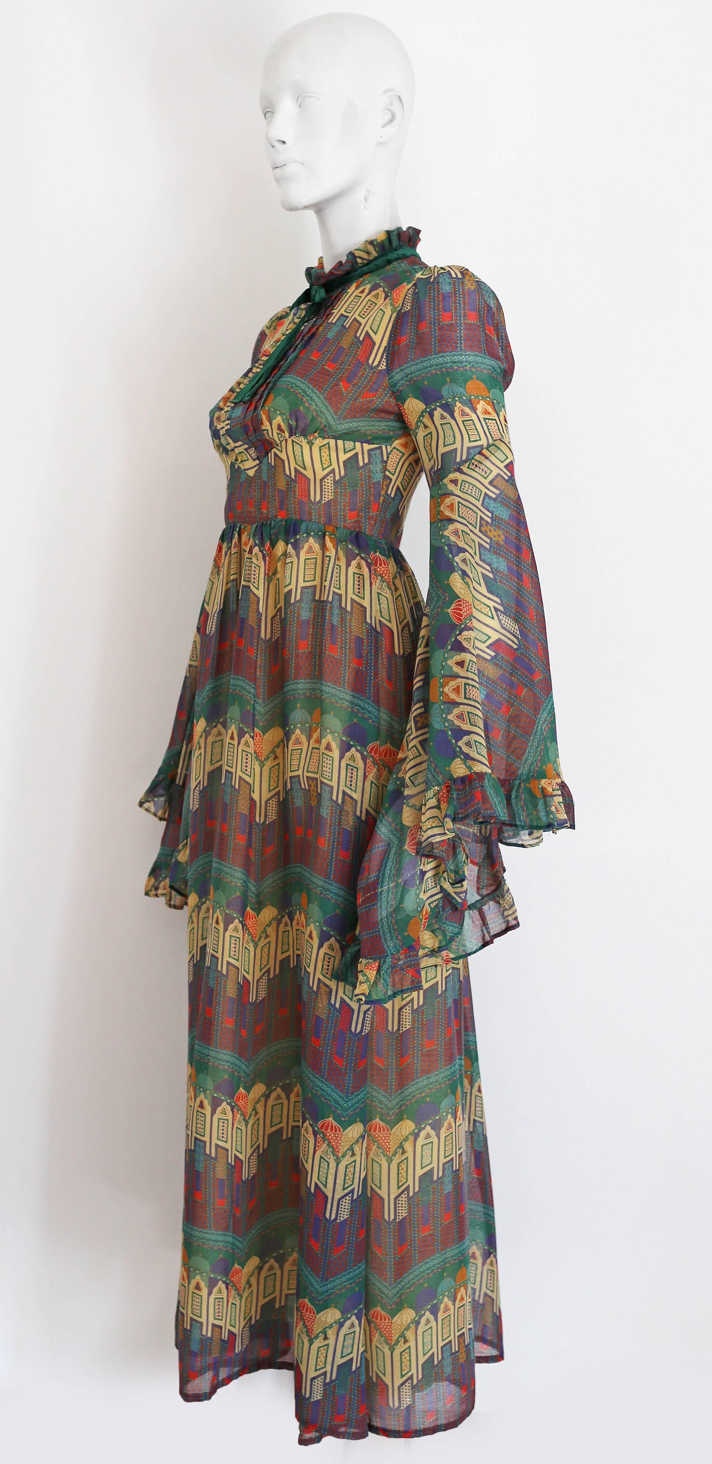 A beautiful novelty print voile summer dress by Samuel Sherman, the dress features exaggerated fluted sleeves and a high ruffled neck with decorative velvet bow. 

Bust: 32 inches 
Waist: 27 inches
Length: 54 inches