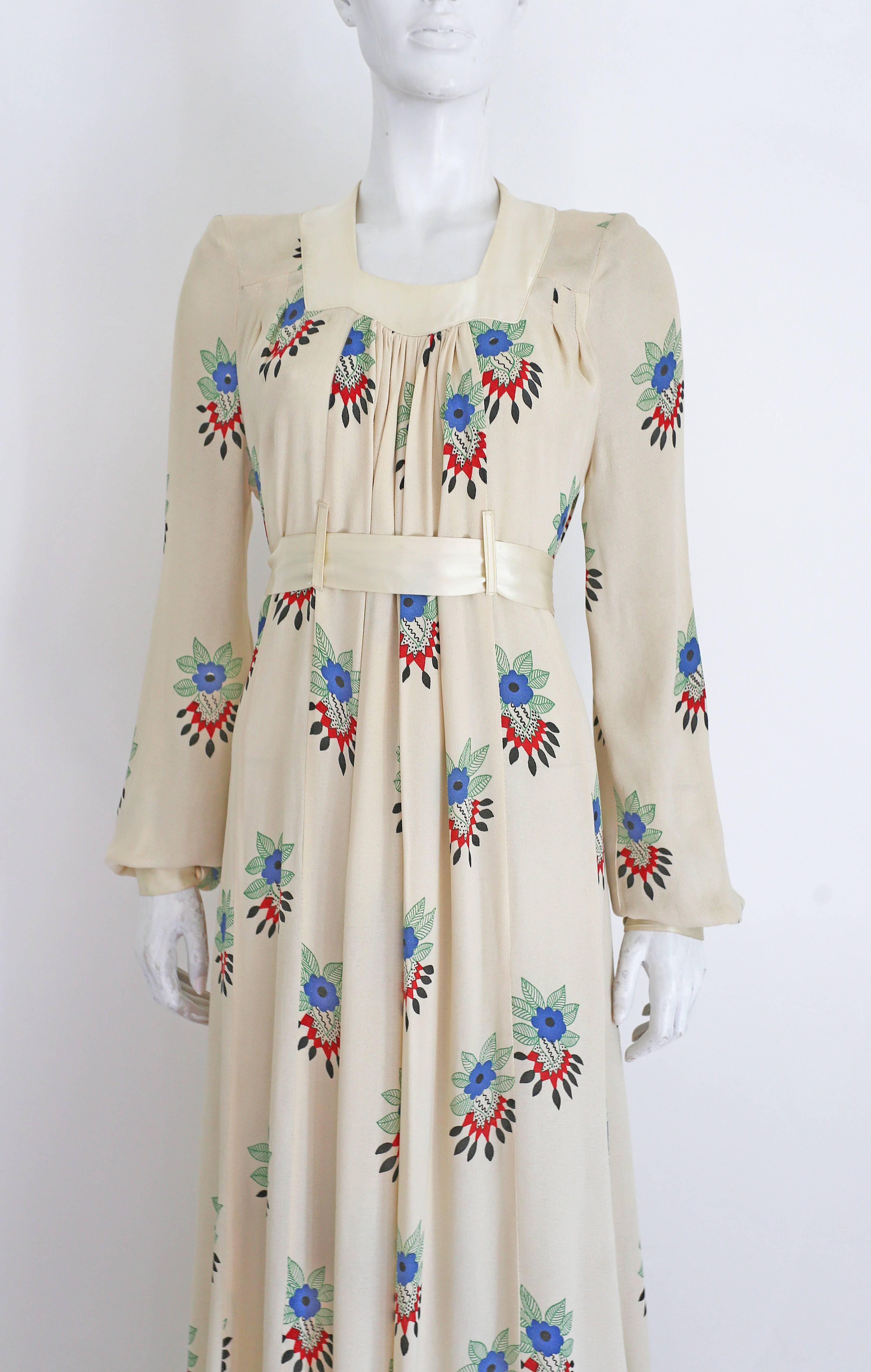 A very rare Ossie Clark summer evening dress in collaboration with his former wife, textile designer Celia Birtwell. The dress has an ivory satin collar which fastens at the rear with two fabric buttons, bishop sleeves with ivory satin cuffs,