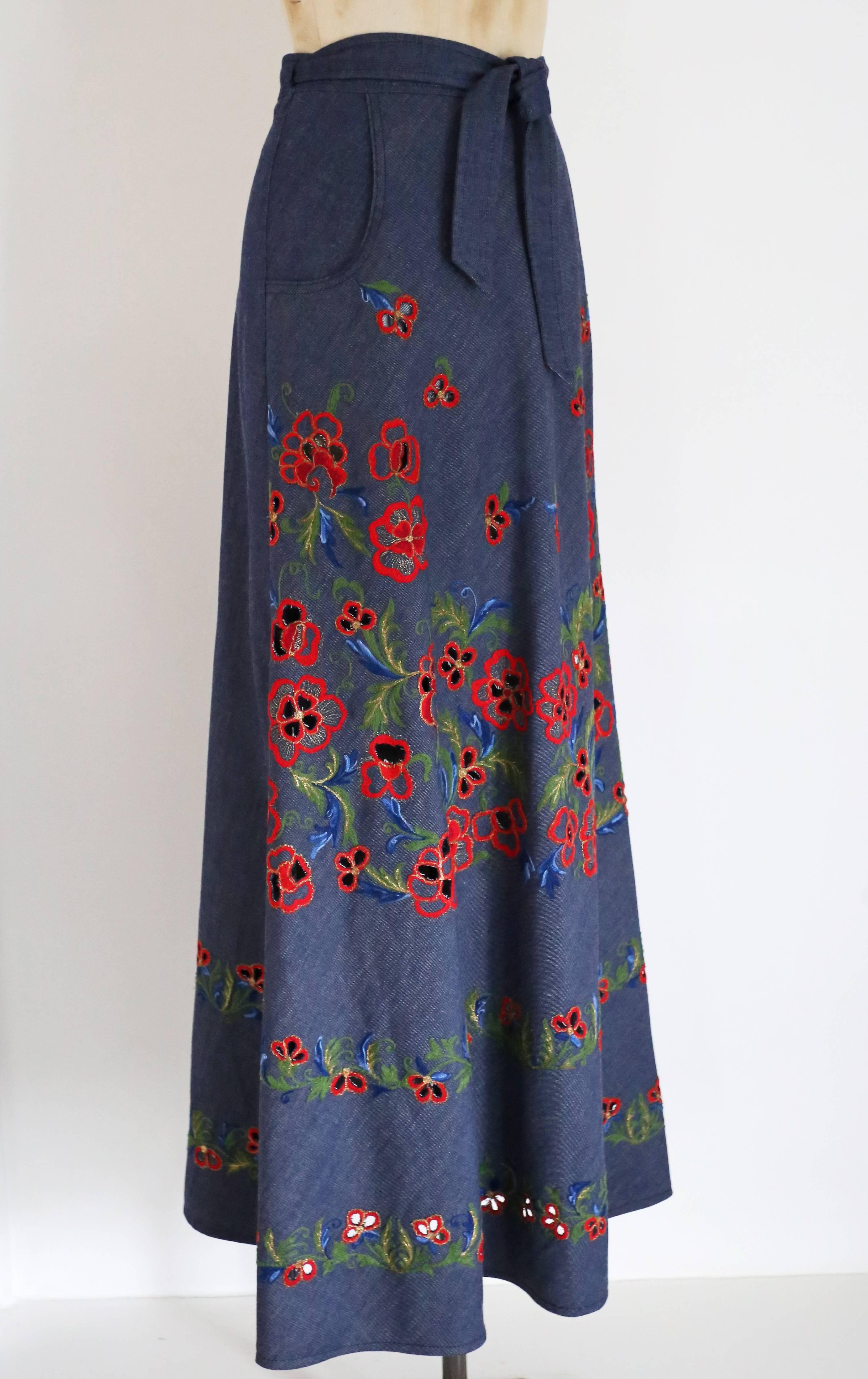 An exquisite Italian couture maxi skirt, circa 1960s by Pirovano. The skirt is in a silk cotton and features splendid floral embroidery throughout with cut-outs in the flowers revealing skin. The skirt is also fastened in a wrap design with the knot