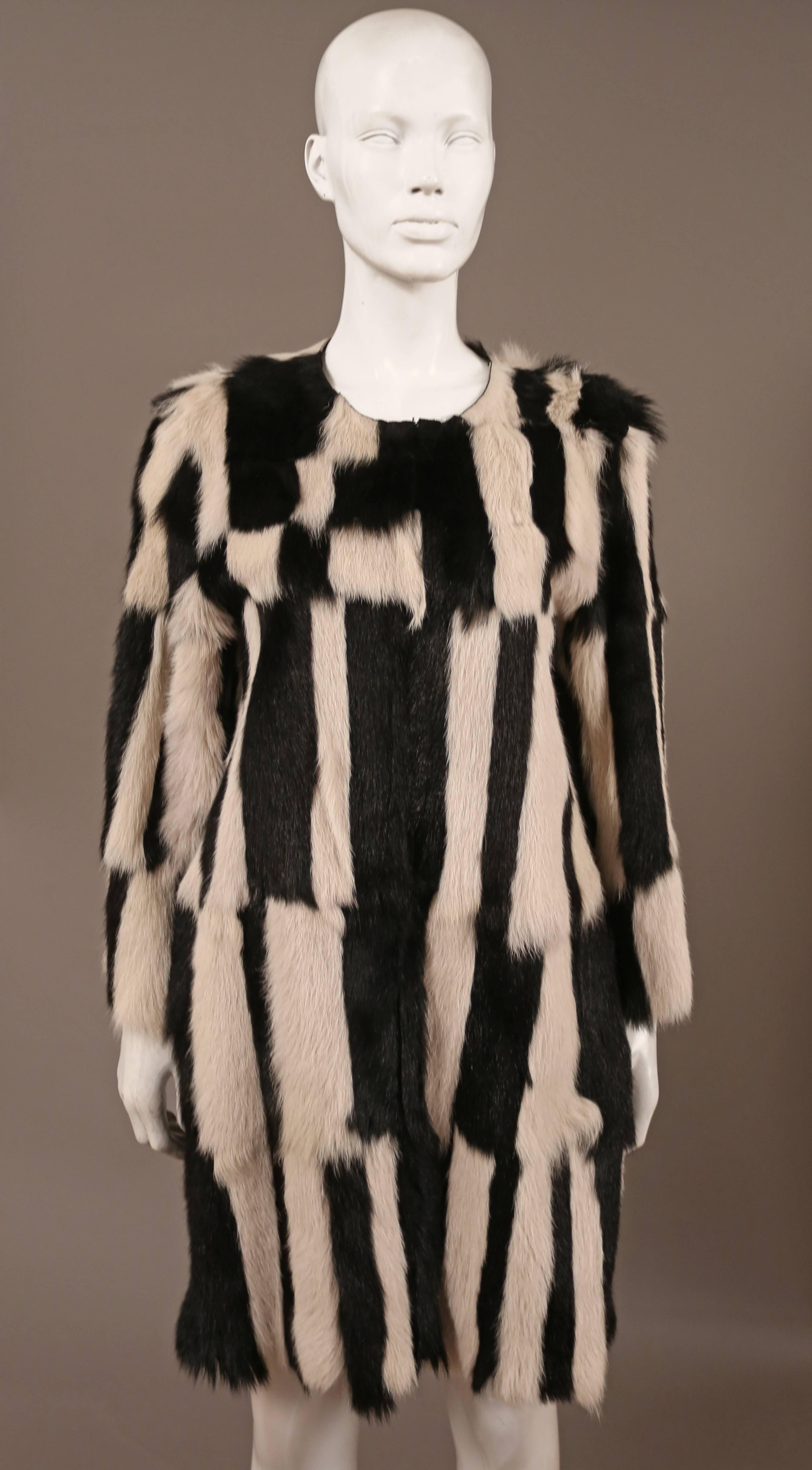 Isabel Marant black and ecru Alea goat hair coat from the 2014 resort collection. The coat features front slit pockets, concealed hook fastenings through front and 100% goat hair in a patchwork design. Cut for a slightly loose fit
Supple,