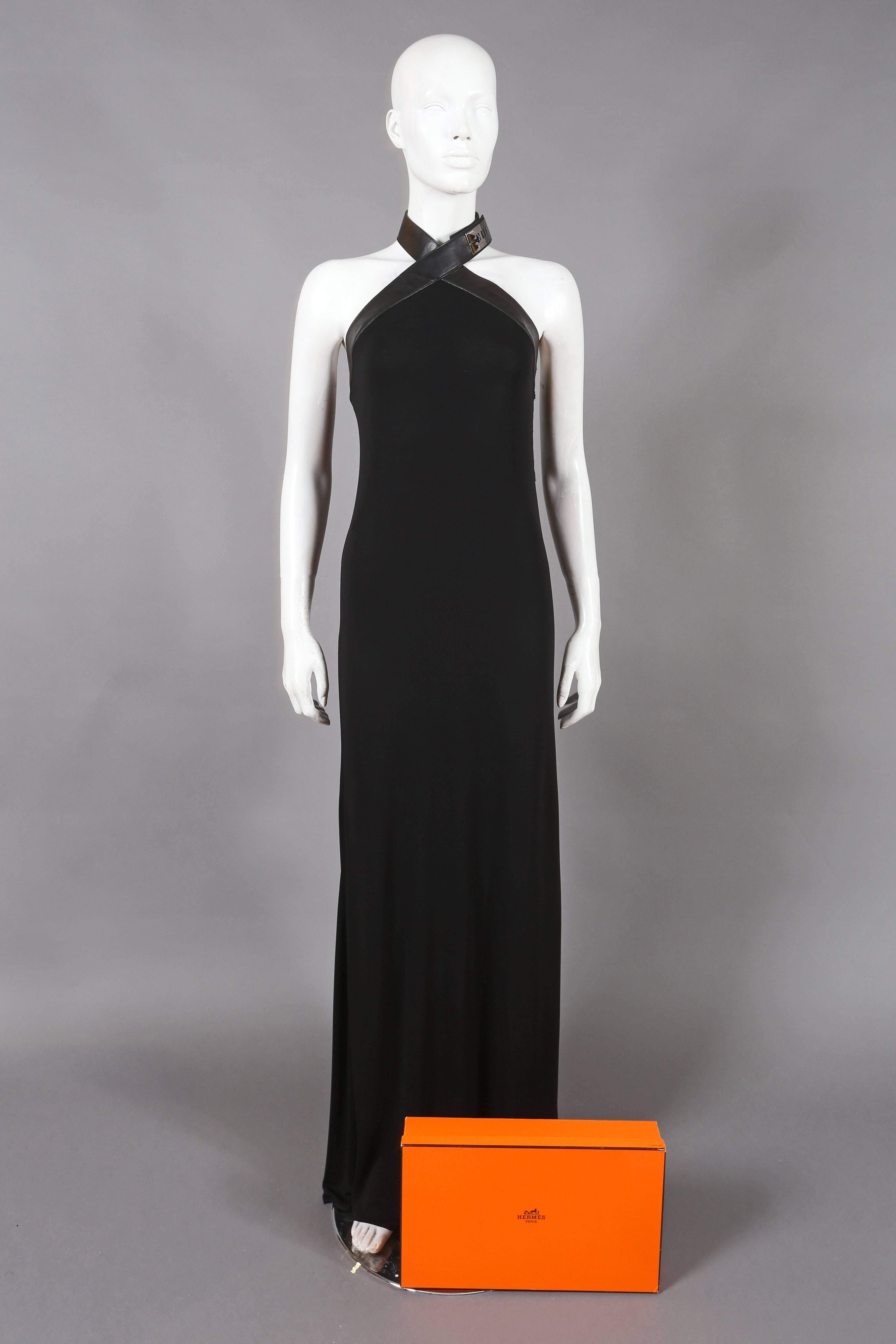 Fine and rare HERMES black silk jersey evening dress from the autumn - winter 2009 - 2010 collection designed by JEAN PAUL GAULTIER. The dress features a black leather halter neck strap with a palladium Collier de Chien lock closure. 

Stamp 'N'