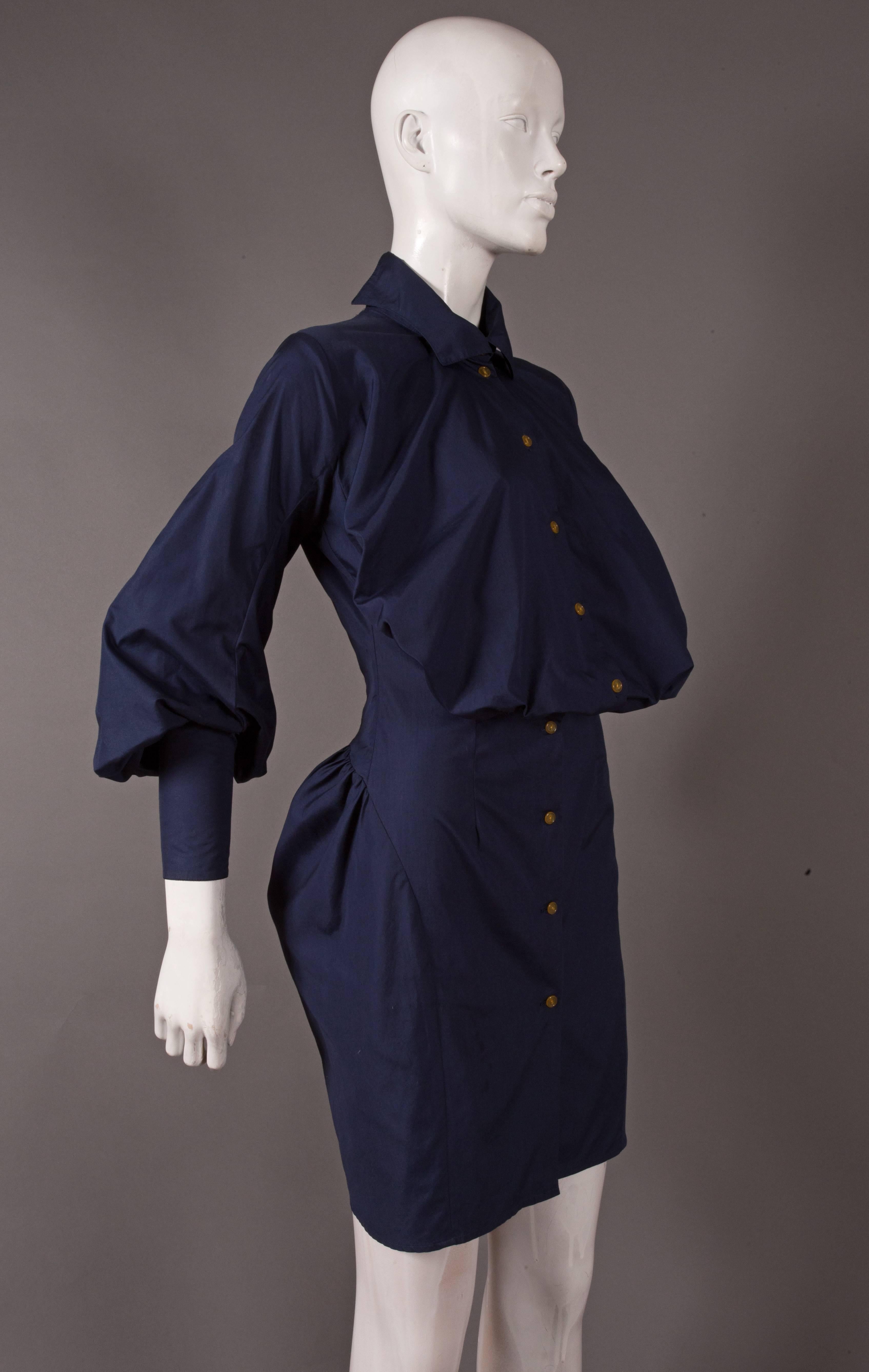 Vivienne Westwood navy cotton shirt dress, circa 1990s. The dress features a balloon like chest, high neck collar, bishop sleeves and a bustle.

