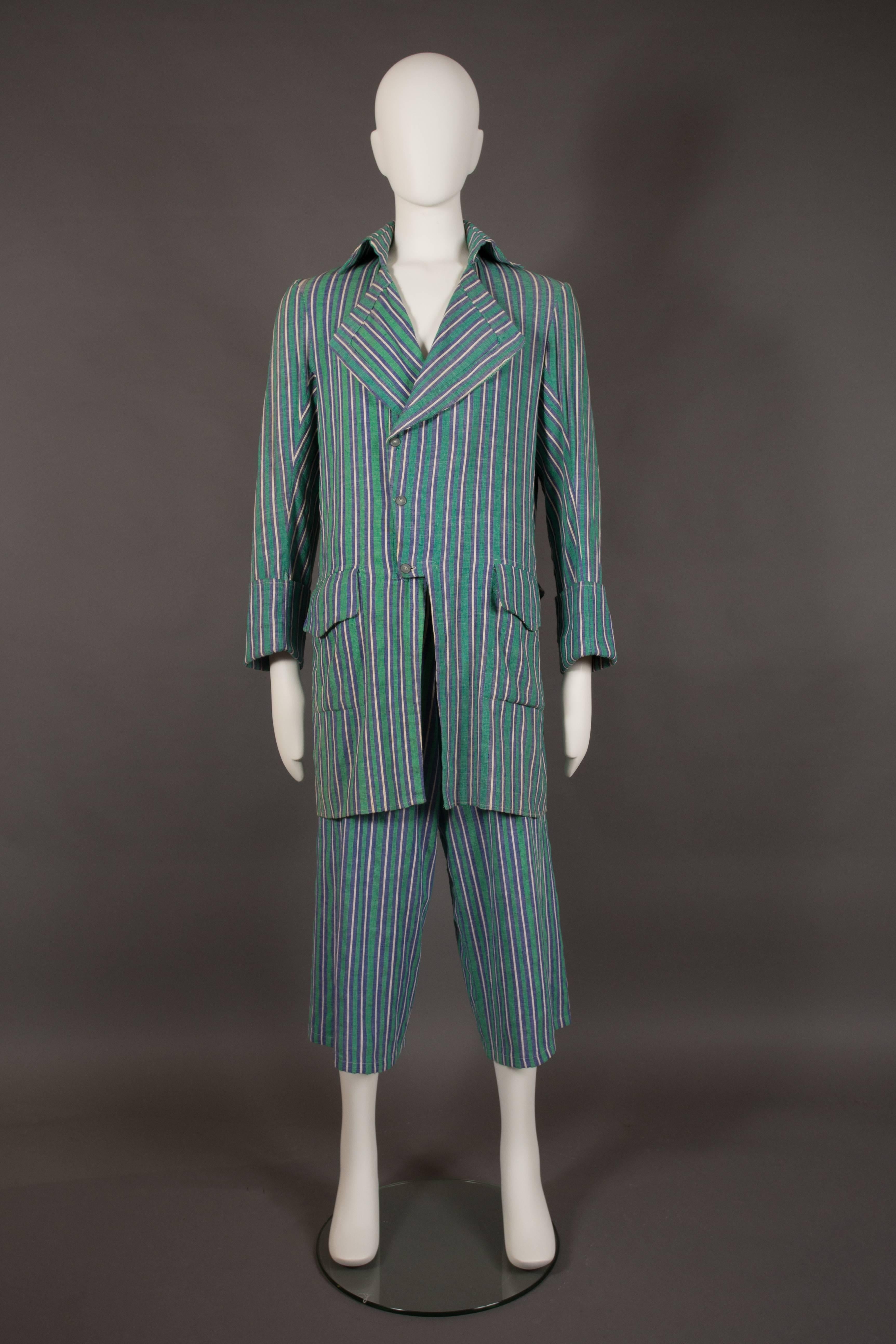 A rare pantsuit by Worlds End, designed by Vivienne Westwood and Malcolm Mclaren, circa 1981.

Pirate inspired design, blue, white and green striped cotton, two front flap pockets, silver metal buttons throughout, turnover cuffs and cropped wide