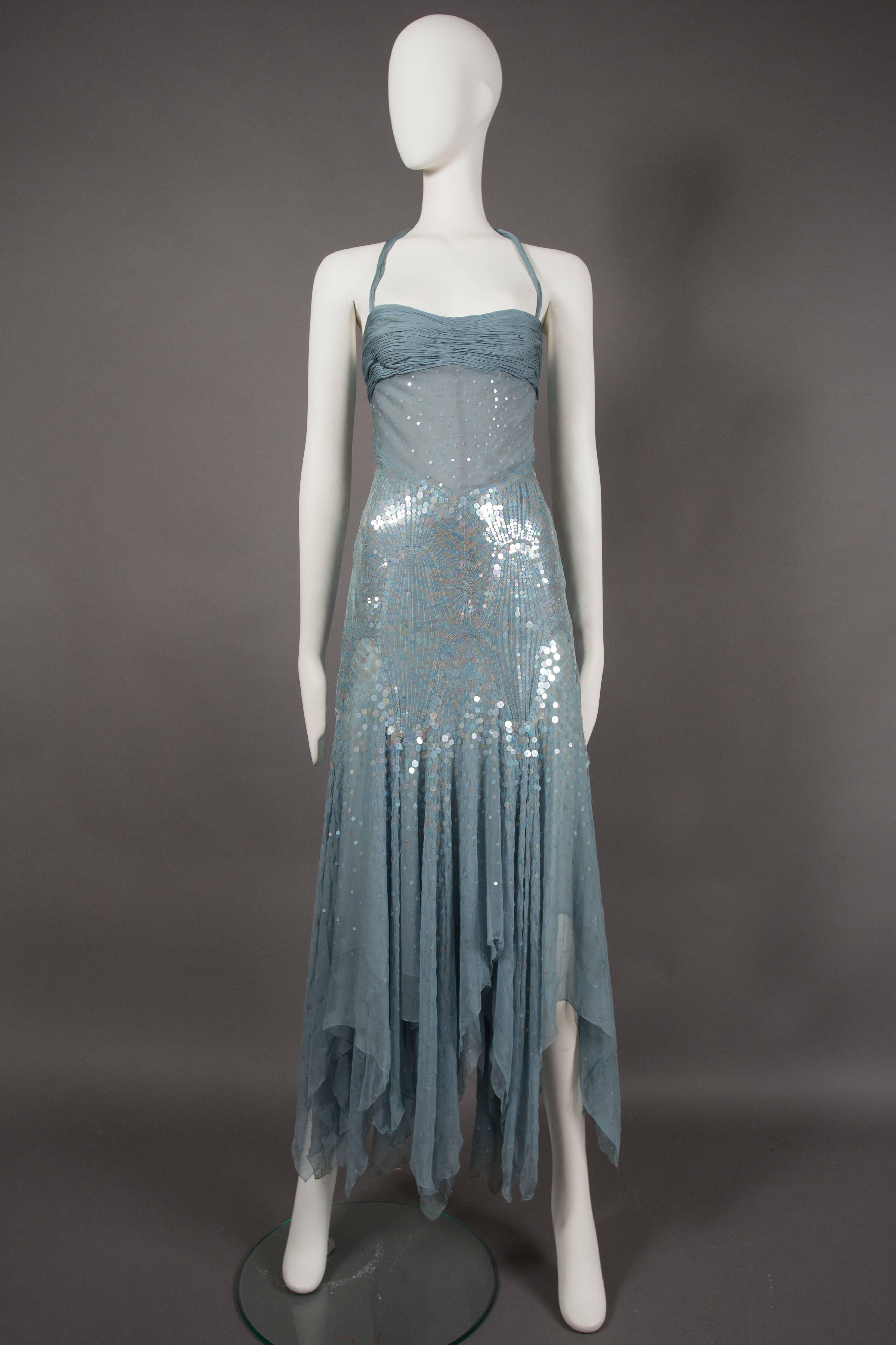 A rare haute couture Atelier Versace evening dress, circa 2003. Halter-neck, pleated bust, internal padded bra, and leotard, skirt with handkerchief hem, thousands of hand-sewn transparent sequins and internal boning on the bodice. 