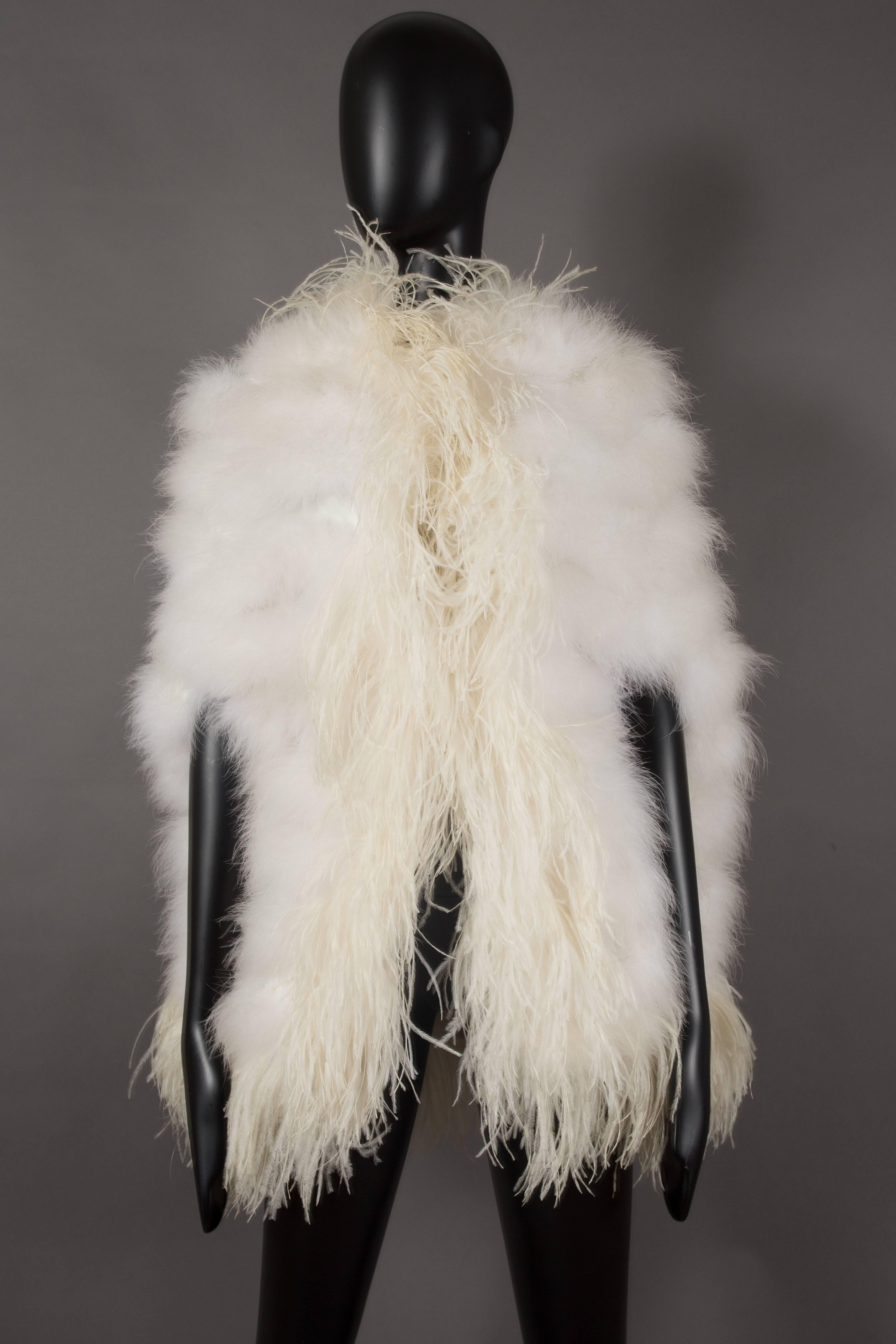 A beautiful evening cape composed of ivory marabou feathers with ostrich feather trim, circa 1960s. 