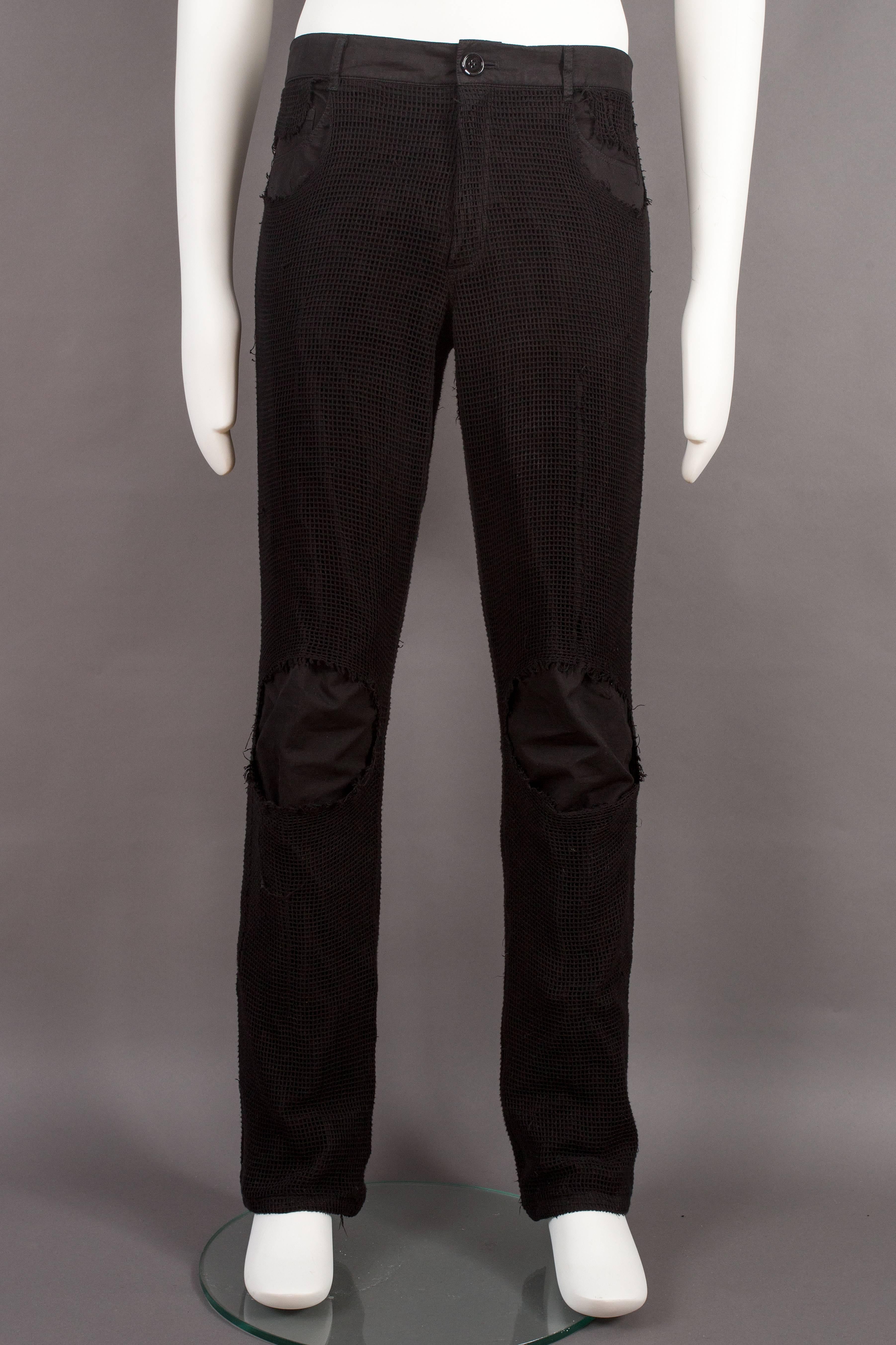 Raf Simons black jean pants with distressed net overlay, 'consumed' spring summer 2003. 

