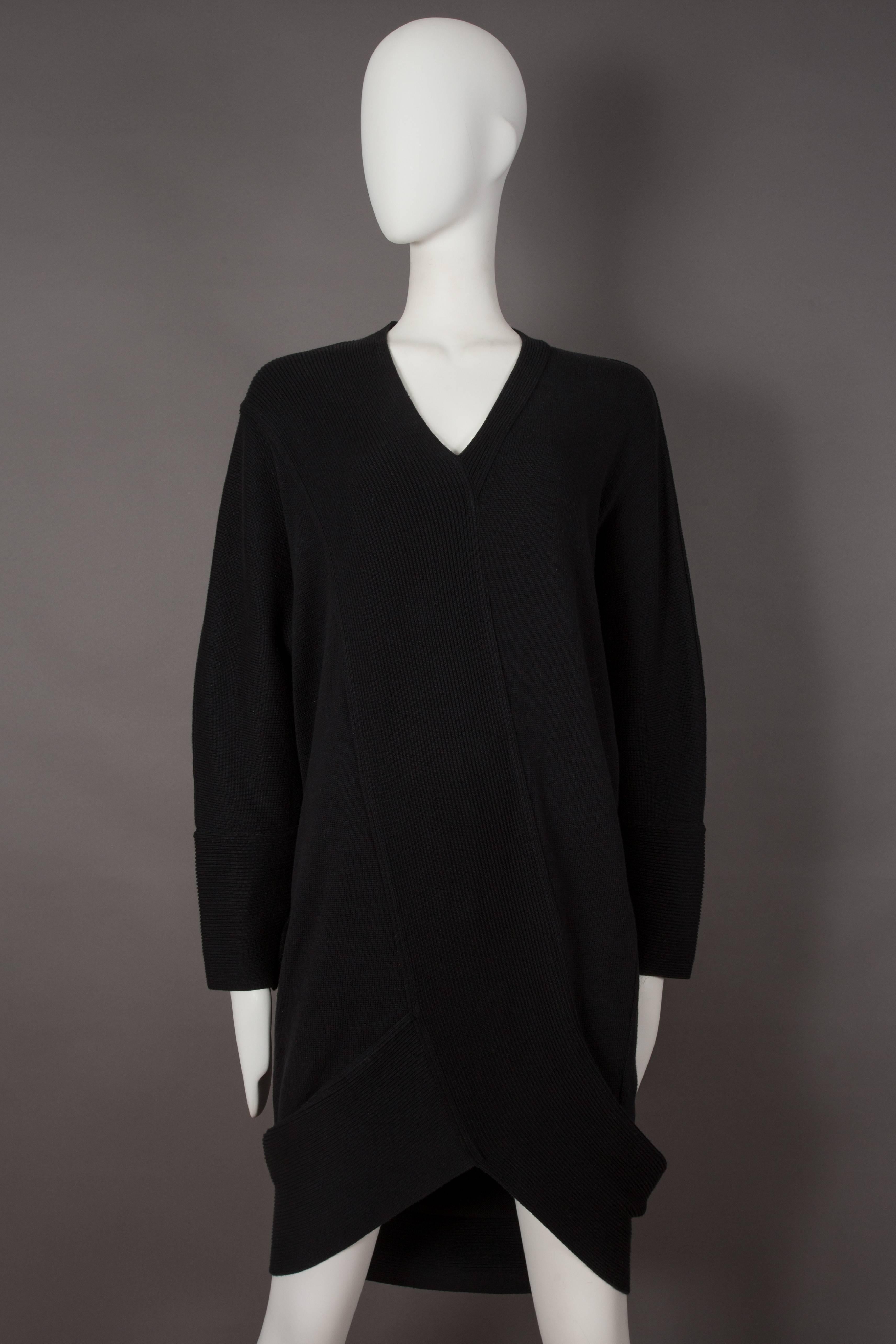 Early Issey Miyake black ribbed knit sweater dress, circa 1980s. The dress features a v-neck collar and large ribbed trim.