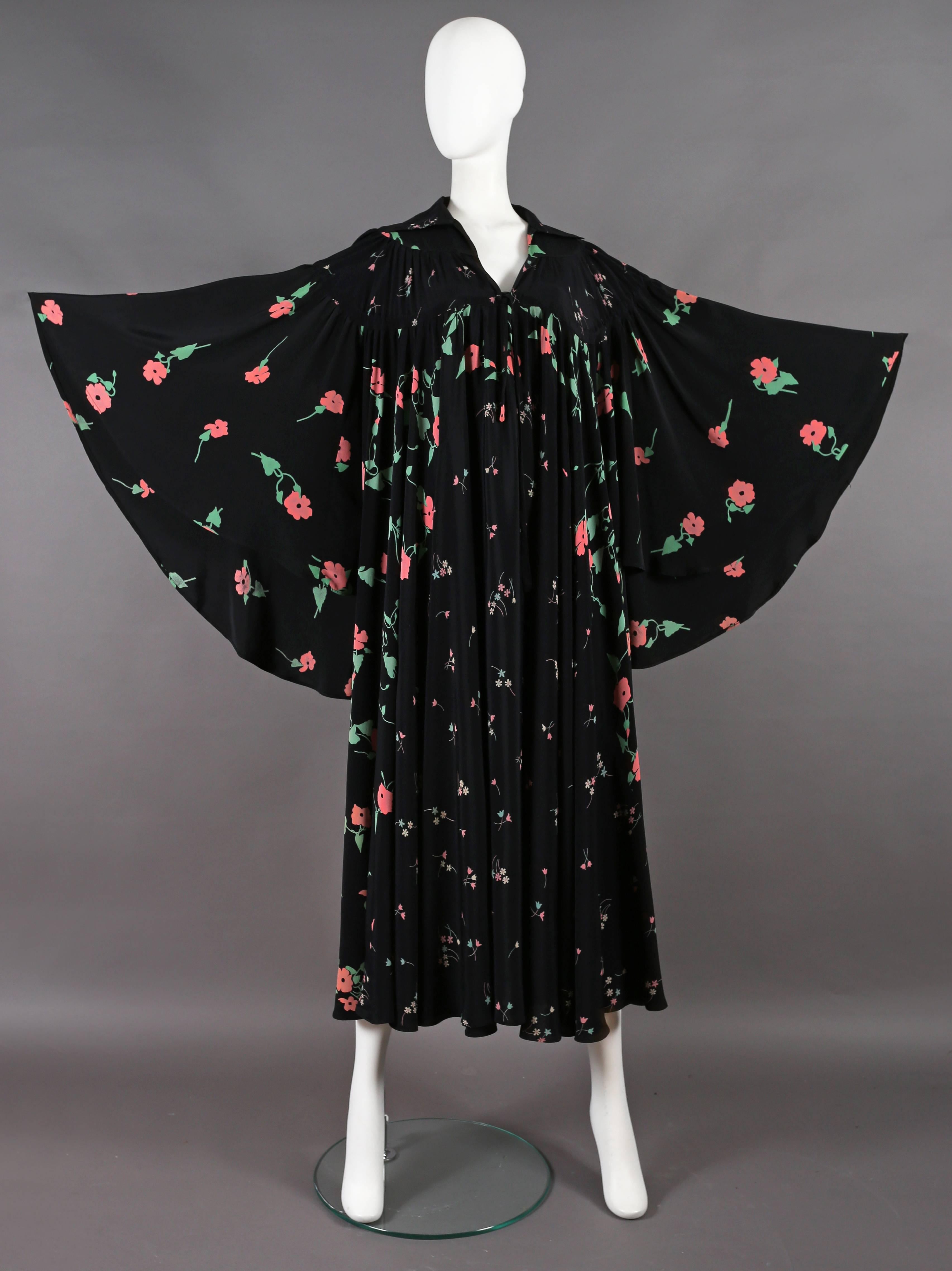 Exquisite and extremely rare Ossie Clark angel dress from his couture line with the 'Busy Lizzie' print by Celia Birtwell, circa 1972. 

The dress features a drawstring fastening on the yoke, pointed open collar, enormous angel sleeves and pleated
