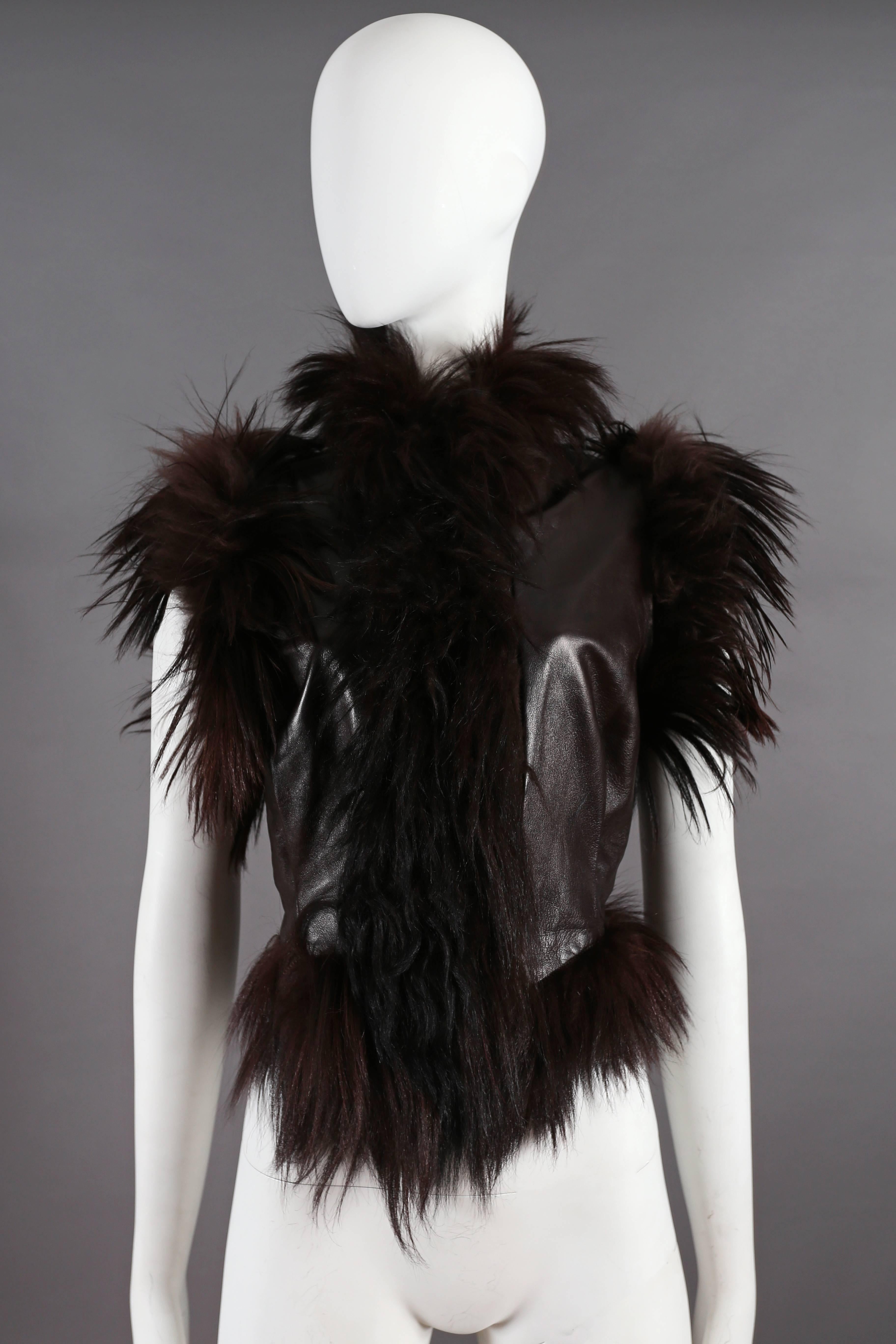 A rare Alexander McQueen brown leather gillet jacket with long goat hair trim from the 'Eshu' Autumn-Winter 2000 collection. 