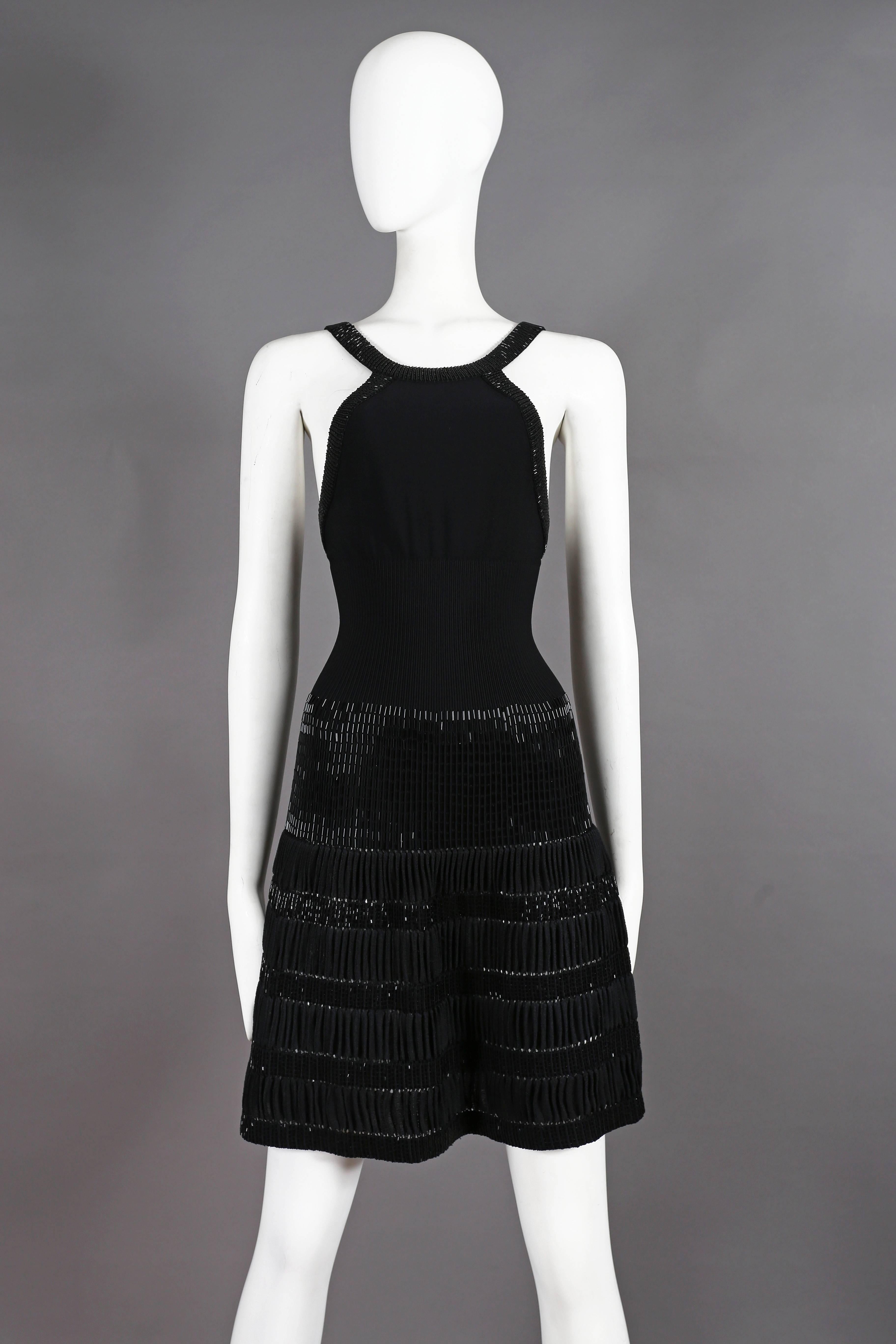 Introducing a striking Azzedine Alaia black evening mini dress, a true masterpiece crafted from a luxurious silk-viscose fabric that hugs the figure flawlessly. This alluring dress showcases unparalleled artistry and attention to detail.

The