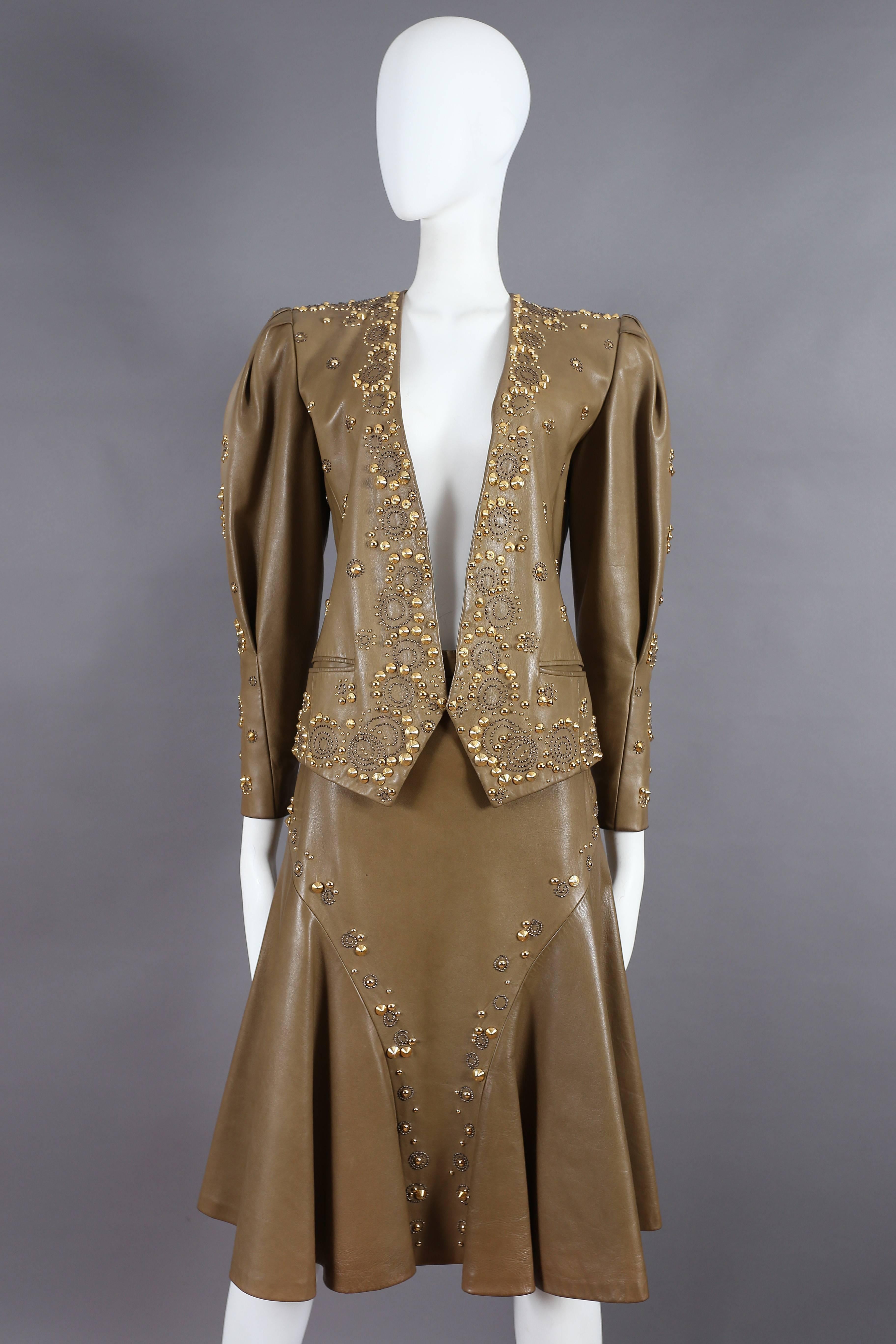 Exquisite Ted Lapidus olive green leather skirt suit, circa 1970s. The suit features western style gold studs throughout and silk lining.