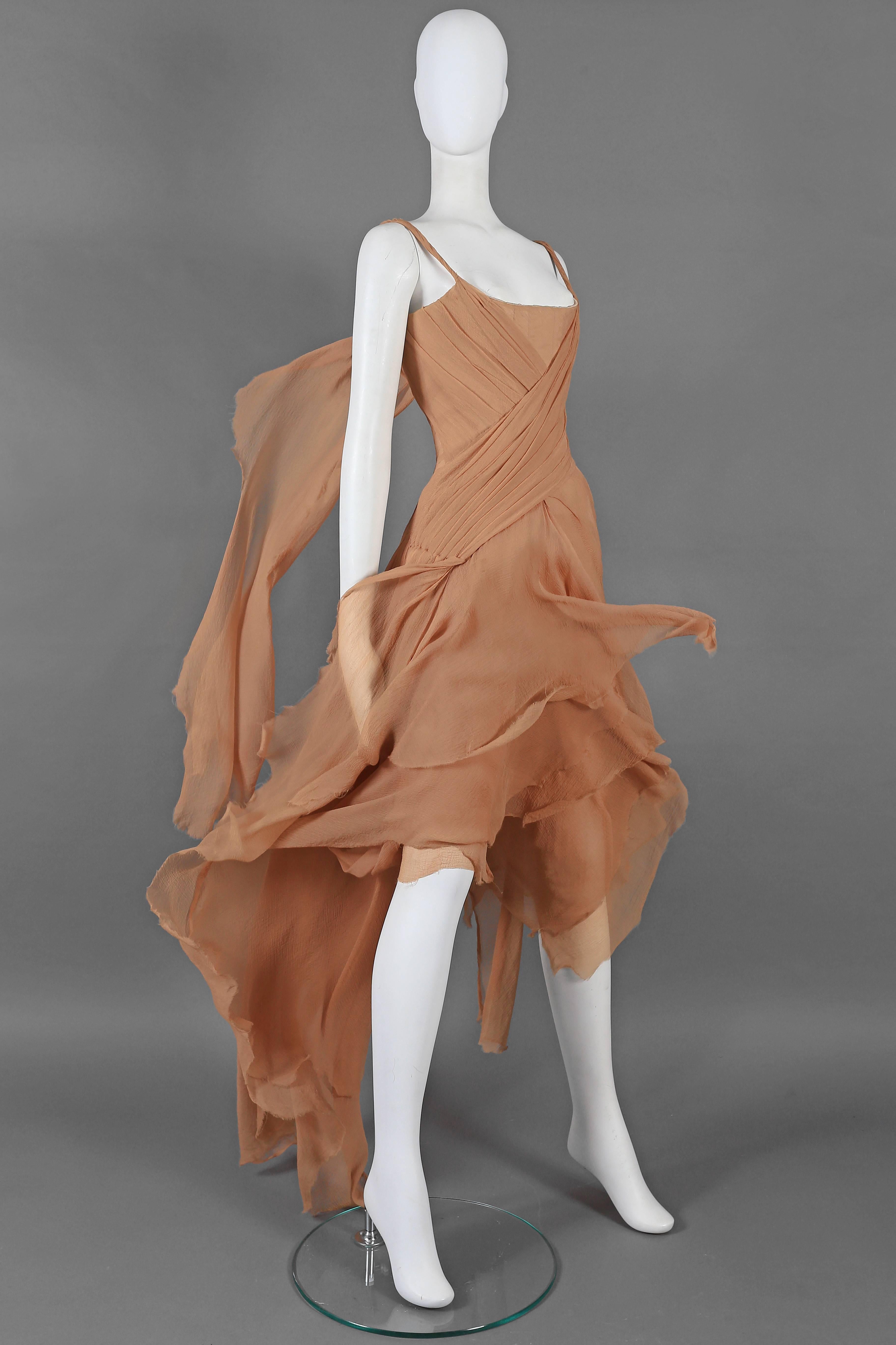 Exquisite and rare Alexander McQueen nude silk chiffon evening gown for the 'Irere' Spring-Summer 2003 collection. The dresses features a corsetted inner bodice covered with cross-over swathes of chiffon, floating panels with ragged edges to the