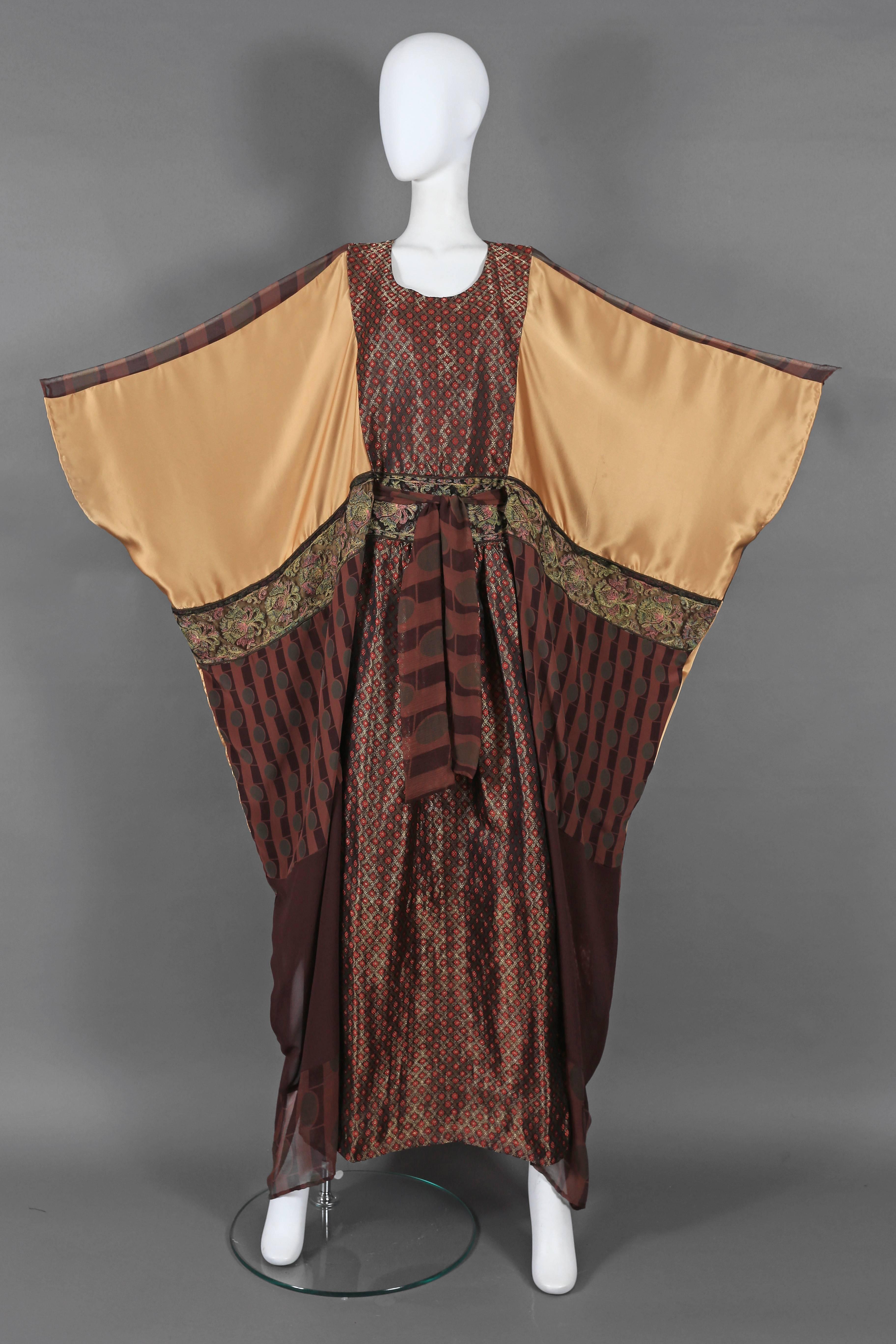 An exceptional and rare Thea Porter Couture evening caftan from the 1970s. The caftan features a beautiful Indian silk brocade fabric, three-dimensional lace, gold-tone 100% silk and a splendid art deco pattern printed on silk chiffon.  

Thea