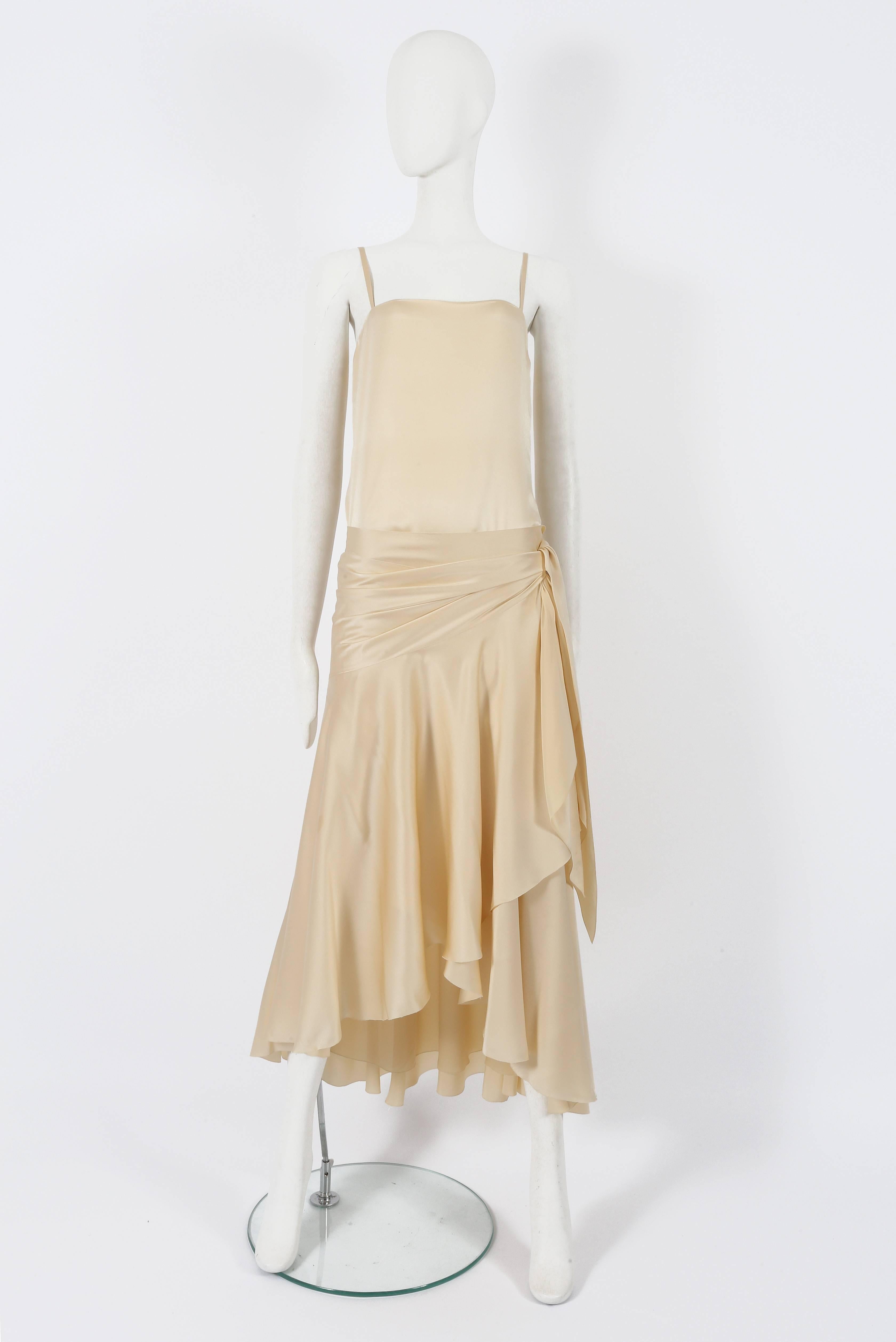Christian Dior Haute Couture by Marc Bohan ivory silk two-piece evening ensemble, Autumn Winter 1978. The ensemble is made up of a silk slip dress with spaghetti straps and metal zip closure and a wrap skirt which can be worn on the hips or styled