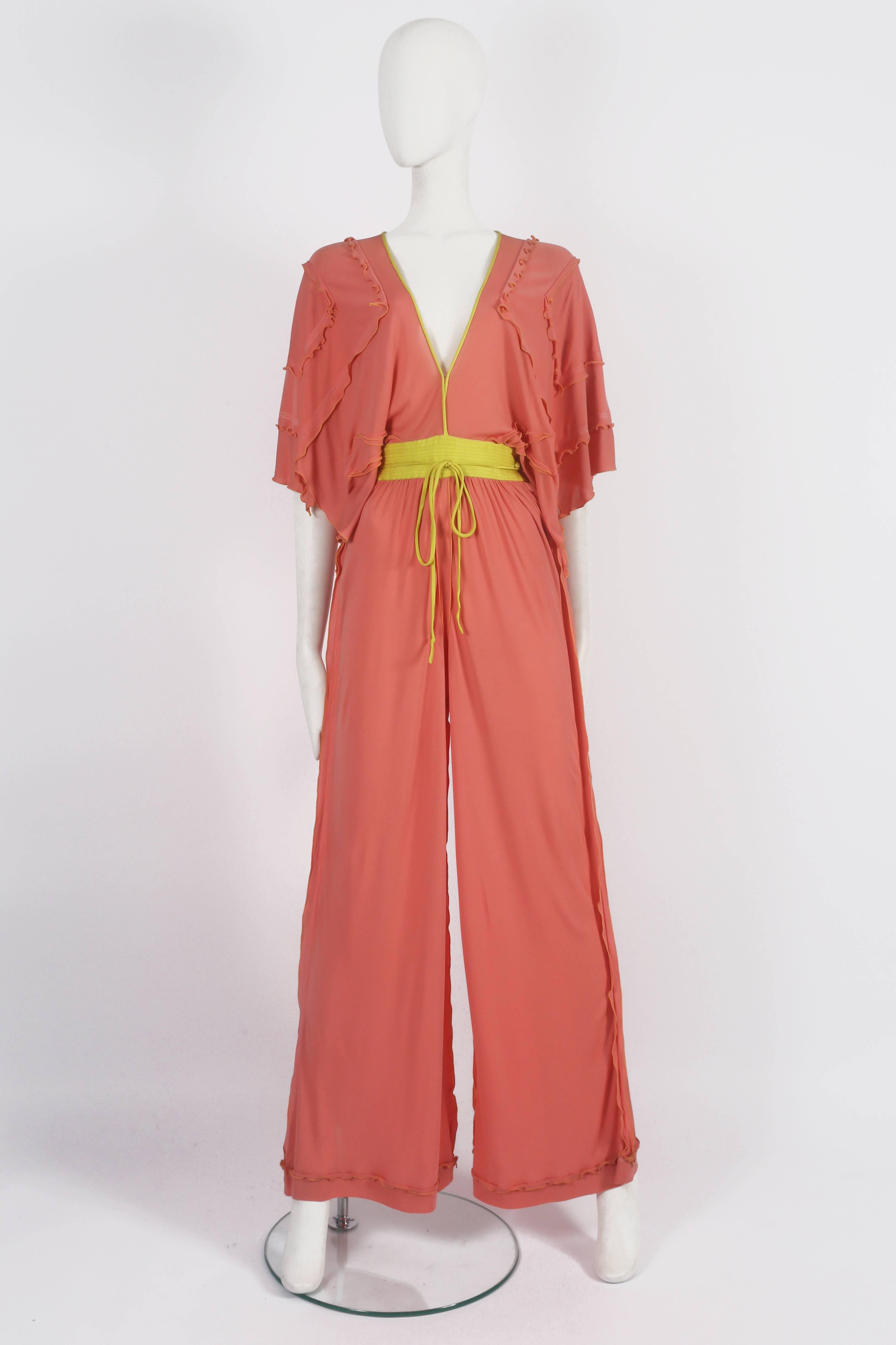 A rare evening jumpsuit by Zandra Rhodes in a salmon pink fine jersey with yellow satin belt and waist ties. 