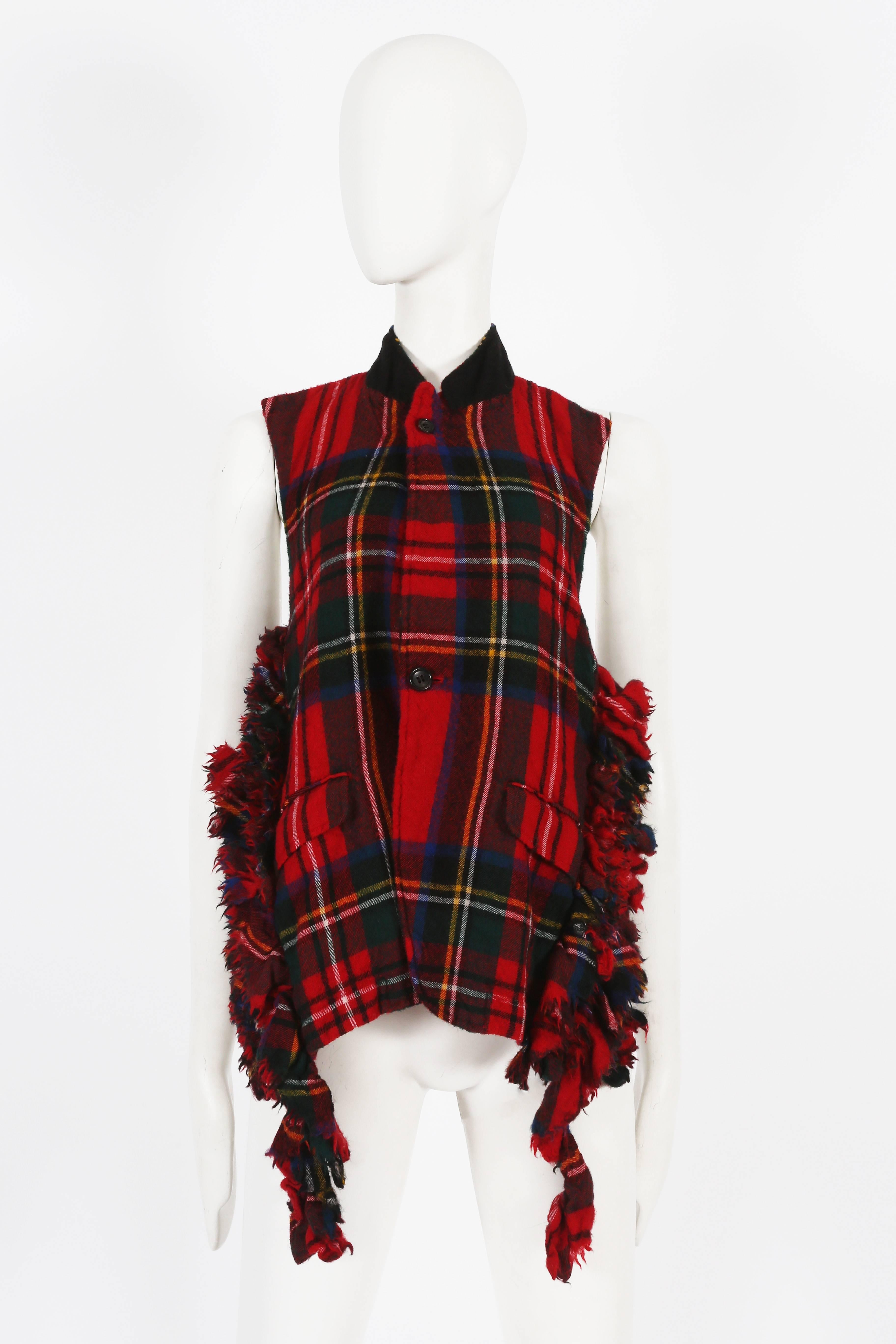 Presenting a rare Comme des Garcons red tartan boiled wool waistcoat, a true collector's gem from the autumn-winter 2000 collection. This waistcoat showcases the brand's signature creativity and unique design.

Crafted from boiled wool in a striking