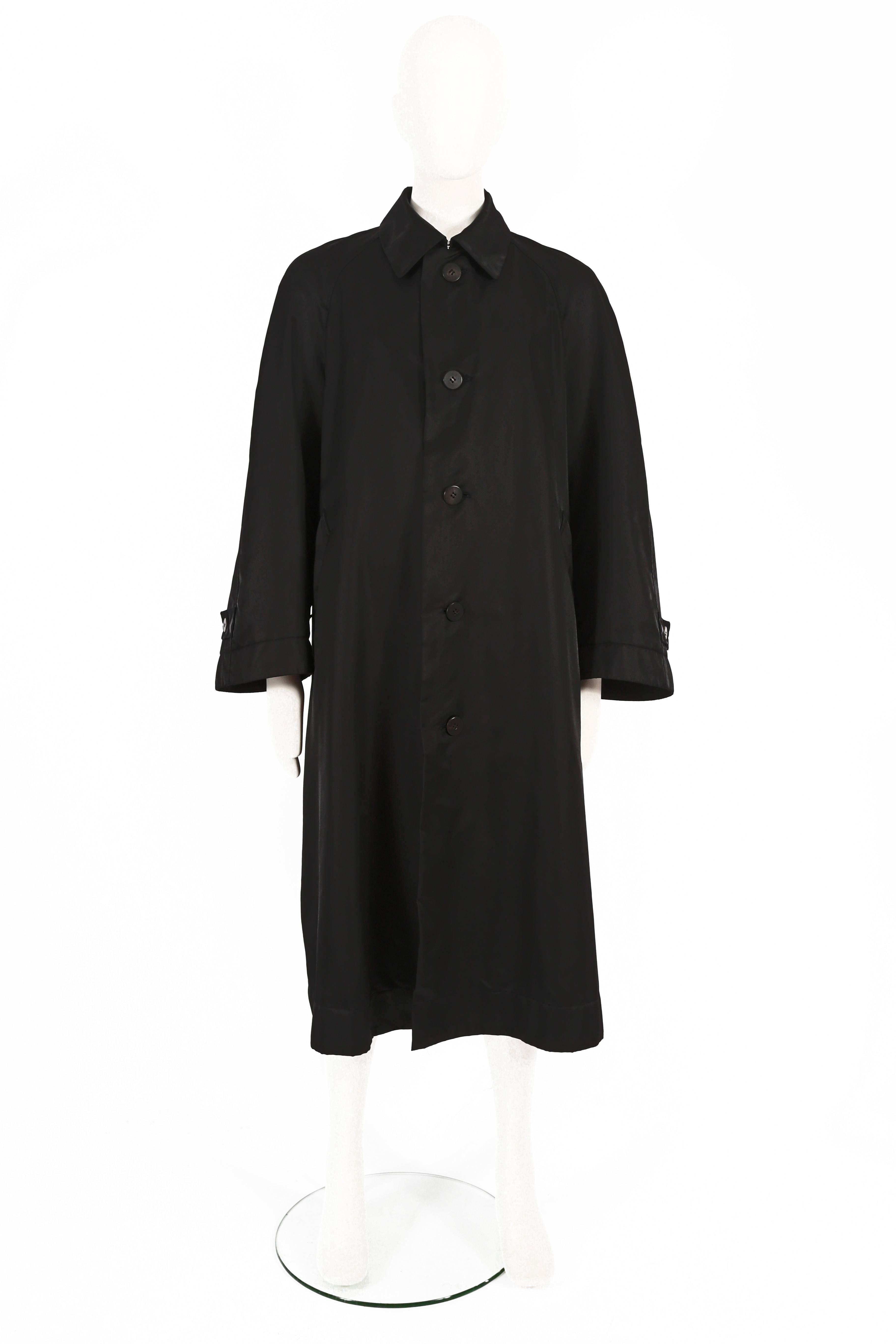 Introducing an Issey Miyake Men's oversized black nylon coat, a timeless and versatile piece from the 1990s. This coat showcases Issey Miyake's signature design aesthetic and commitment to both style and functionality.

The coat features a classic