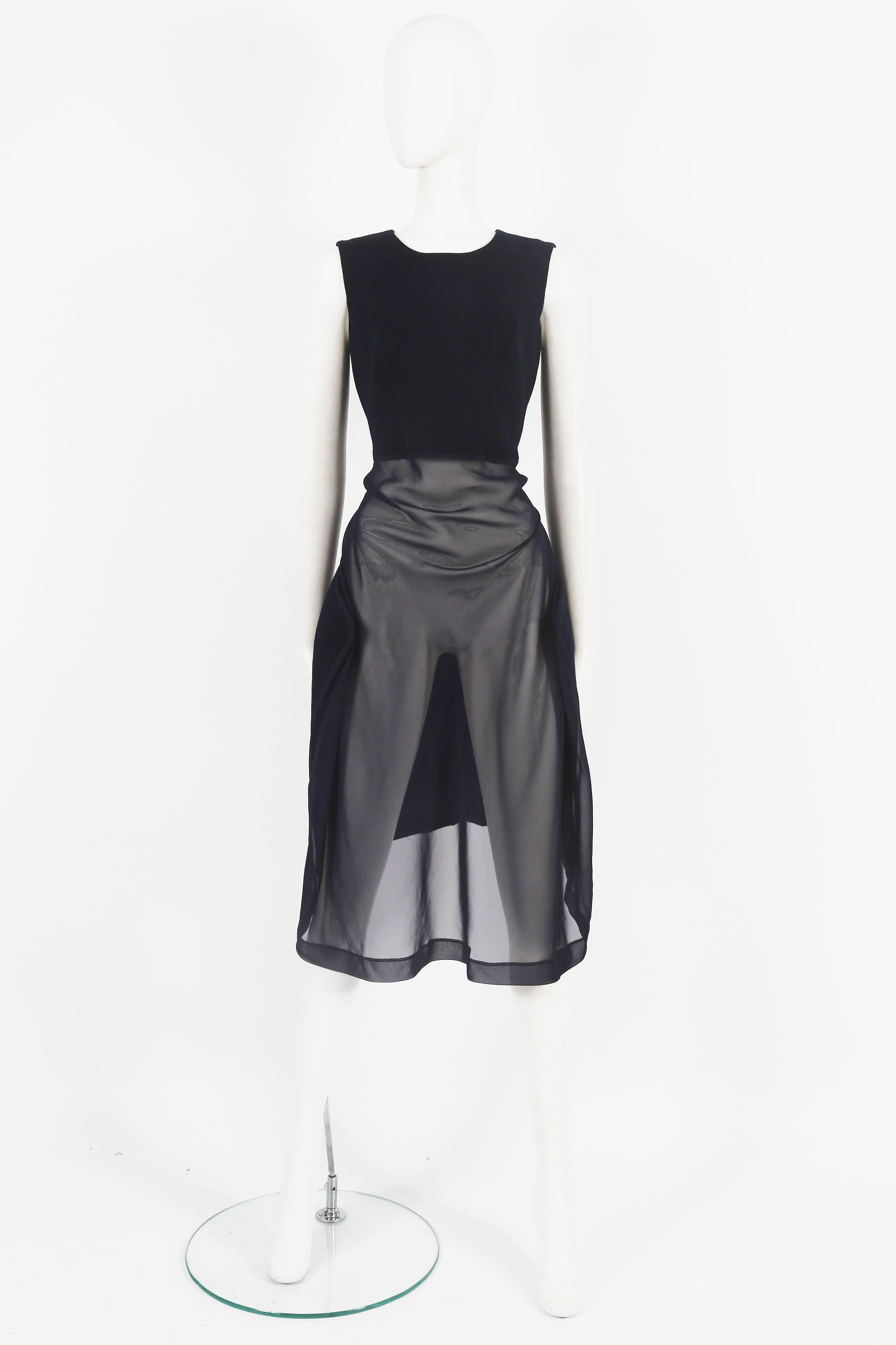 Introducing an avant-garde Comme des Garcons deconstructed wool and chiffon dress, an exceptional piece from the autumn-winter 1997 collection. This dress exemplifies the brand's innovative design and unconventional approach to fashion.

The